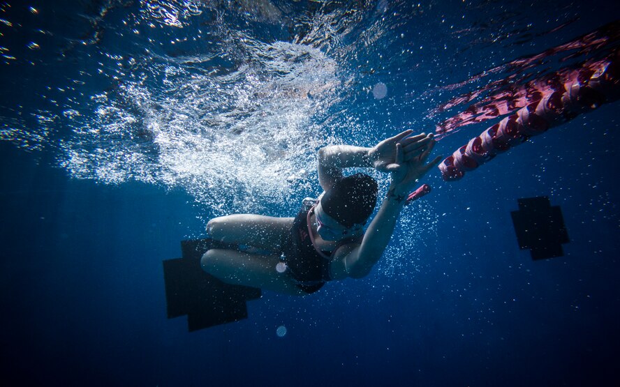 U.S. Air Force Senior Airman Megan Stanton, 366th Medical Operations Squadron medic, pushes off after a flip-turn in the base pool at Mountain Home Air Force Base, Idaho, July 11, 2013. Stanton will usually swim for 1,500 meters without stopping. (U.S. Air Force photo/Tech. Sgt. Samuel Morse)