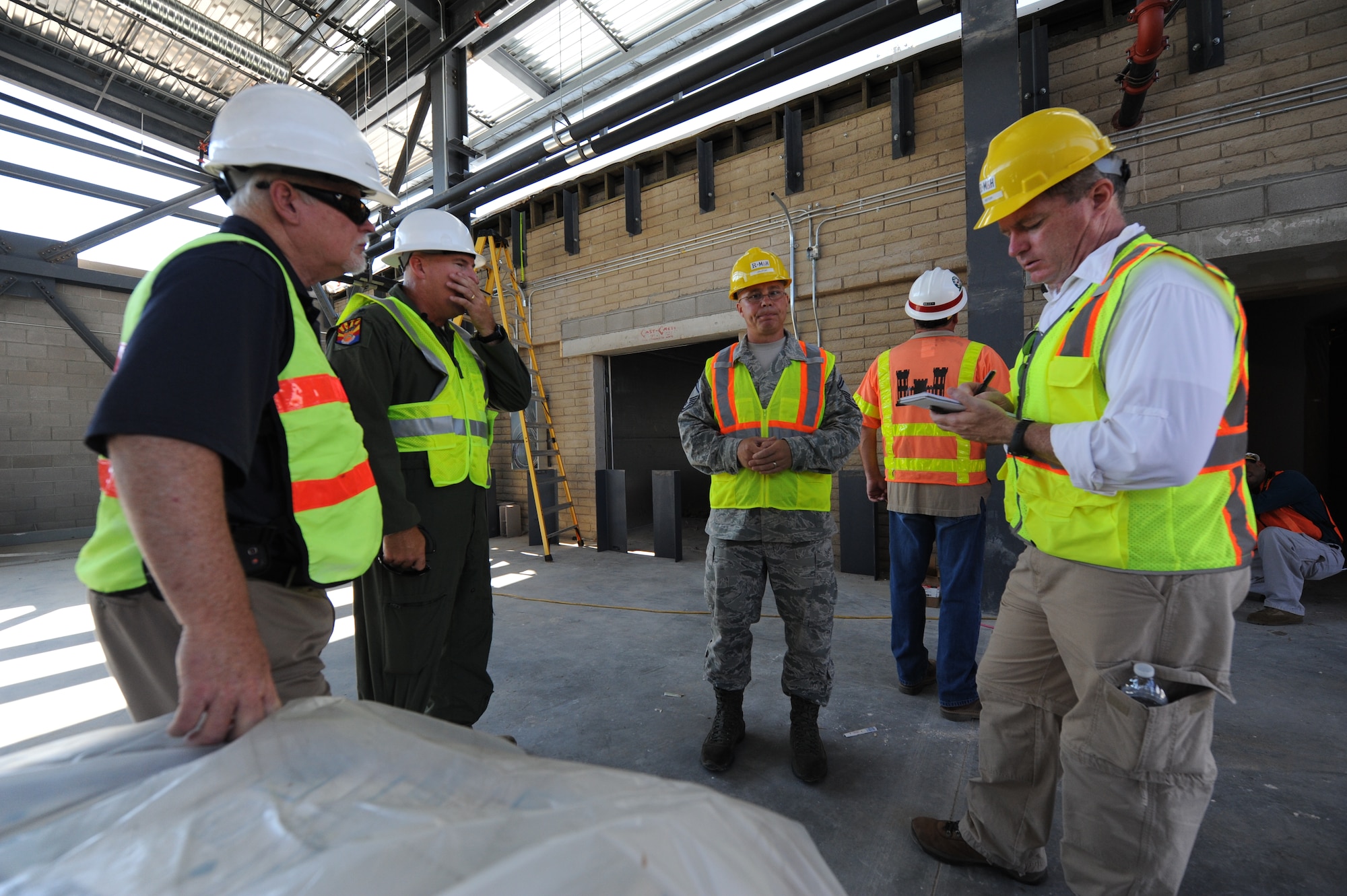 An Arizona Republic reporter takes notes as members of the F-35 construction team show him projects underway on base. (U.S. Air Force photo/Airman 1st Class Devante Williams)