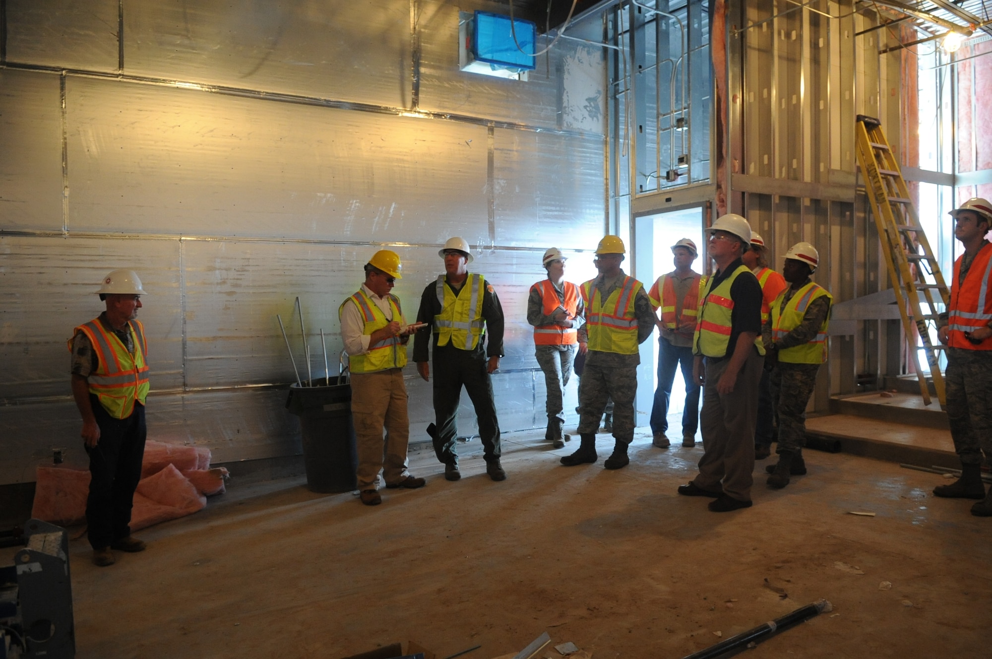 Members of an F-35 construction team give an Arizona Republic reporter a tour of one of the unfinished buildings July 18 at Luke Air Force Base. Luke will eventually have six squadrons and 144 F-35A jets. (U.S. Air Force photo/Airman 1st Class Devante Williams)