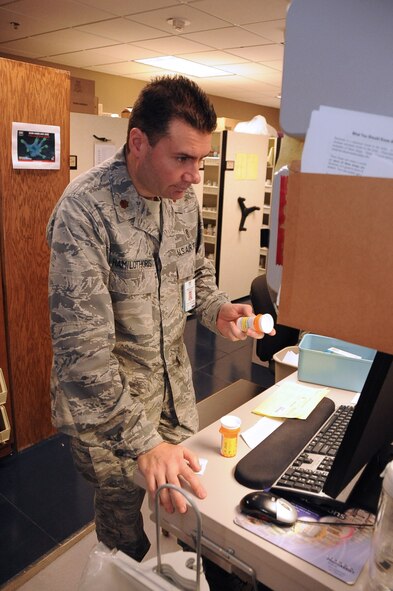 Maj. Achilles Hamilothoris, 2nd Medical Support Squadron Pharmacy flight commander, reviews a customer’s prescription on Barksdale Air Force Base, La., July 17, 2013. Hamilothoris is one of three military finalists nominated for Next Generation Pharmacist’s Military Pharmacist of the Year. (U.S. Air Force photo/Staff Sgt. Jason McCasland)