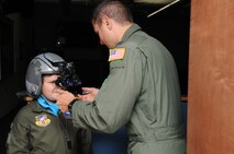 YOUNGSTOWN AIR RESERVE STATION, Ohio -- The 910th Airlift Wing's 54th Pilot for a Day, honorary 2nd Lieutenant Nicholas Greathouse, tries on night vision goggles with the assistance of Air Force Reserve Capt. Adam Schubel, a pilot with the 773rd Airlift Squadron, here, July 24. Pilot for a Day is a community outreach program that works through Akron Children's Hospital Boardman to welcome children with chronic or life-threatening illnesses to the station for a day of military experiences. U.S. Air Force photo by SrA Rachel Kocin.