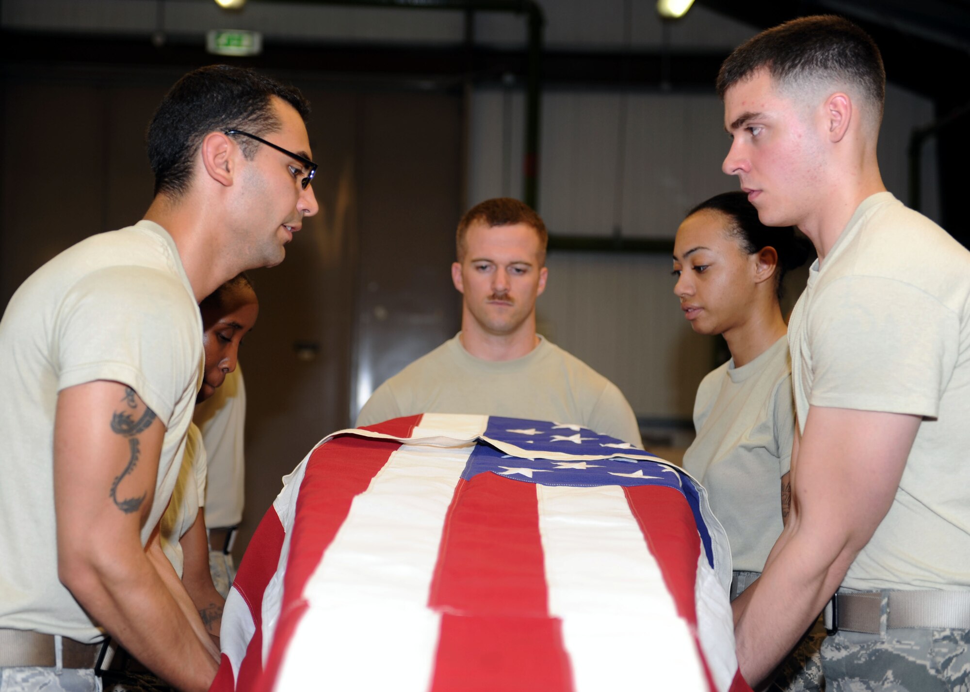 Team Mildenhall Honor Guard members lift an empty coffin July 24, 2013, on RAF Mildenhall, England, while practicing funeral procedures. Honor guard members on RAF Mildenhall practice a variety of procedures and ceremonies every Wednesday to sharpen their skills and present the most professional image possible.  (U.S. Air Force photo by Airman 1st Class Preston Webb/Released)