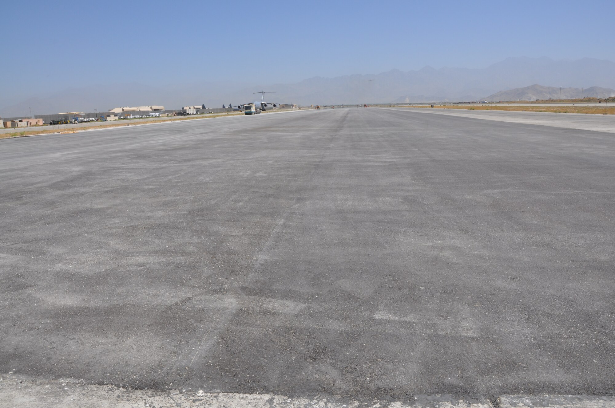 Ongoing runway repairs take place at Bagram Airfield, Afghanistan, July 26, 2013. The first phase of a major runway project on the Department of Defense’s busiest runway is scheduled to be completed here Aug. 10. Phase I included the repair and resurfacing of the Russian runway, built in 1959, to allow it to become a temporary runway while the primary runway is repaired. Soon after, the contractor will start Phase II work on the primary runway, which will last four months.