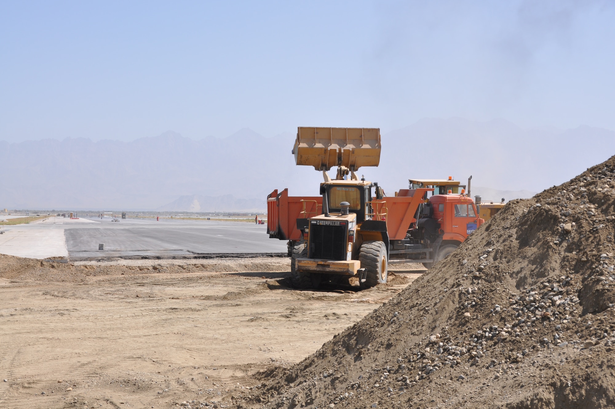 Ongoing runway repairs take place at Bagram Airfield, Afghanistan, July 26, 2013. The first phase of a major runway project on the Department of Defense’s busiest runway is scheduled to be completed here Aug. 10. Phase I included the repair and resurfacing of the Russian runway, built in 1959, to allow it to become a temporary runway while the primary runway is repaired. Soon after, the contractor will start Phase II work on the primary runway, which will last four months.
