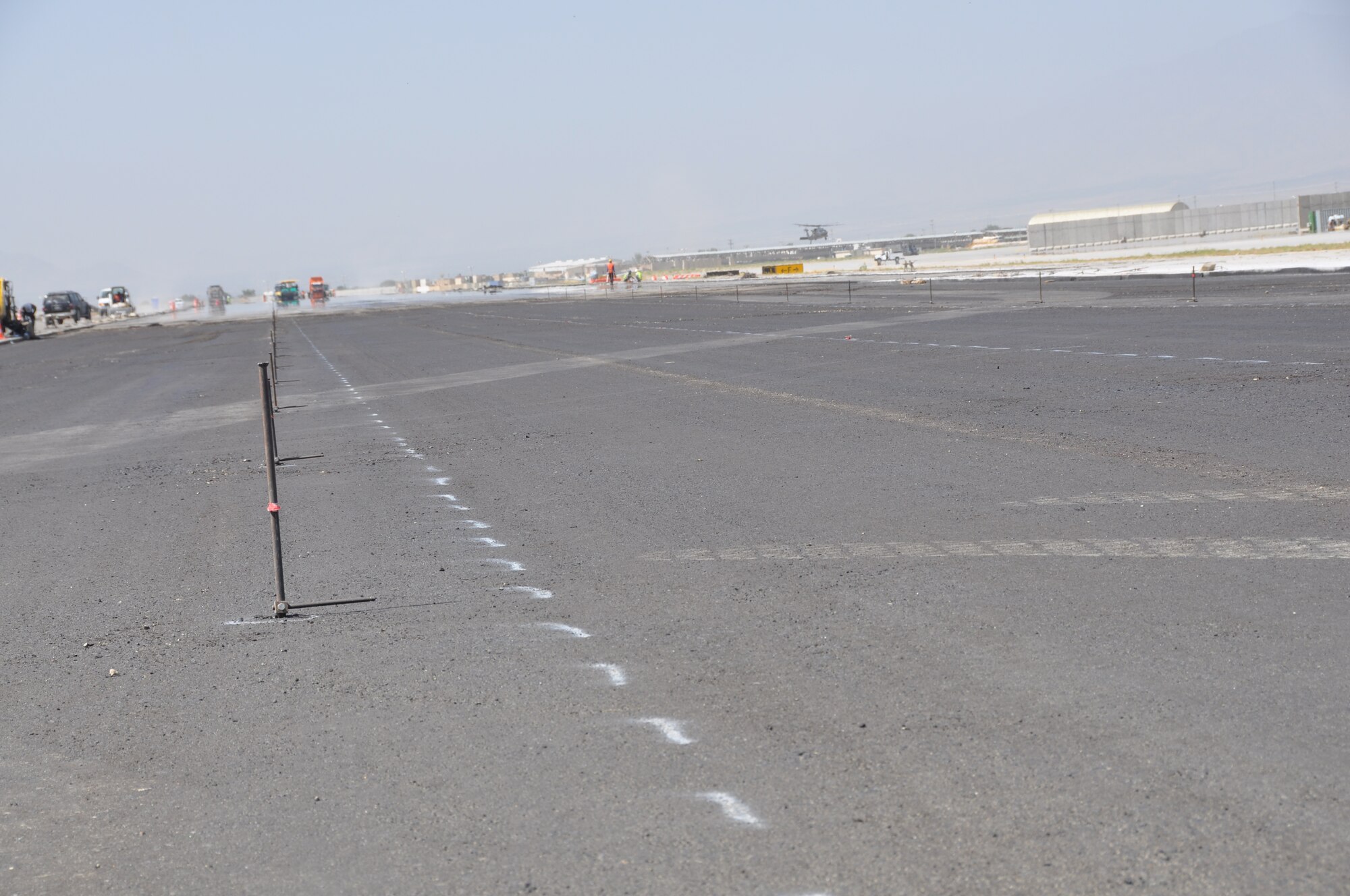 Ongoing runway repairs take place at Bagram Airfield, Afghanistan, July 26, 2013. The first phase of a major runway project on the Department of Defense’s busiest runway is scheduled to be completed here Aug. 10. Phase I included the repair and resurfacing of the Russian runway, built in 1959, to allow it to become a temporary runway while the primary runway is repaired. Soon after, the contractor will start Phase II work on the primary runway, which will last four months.