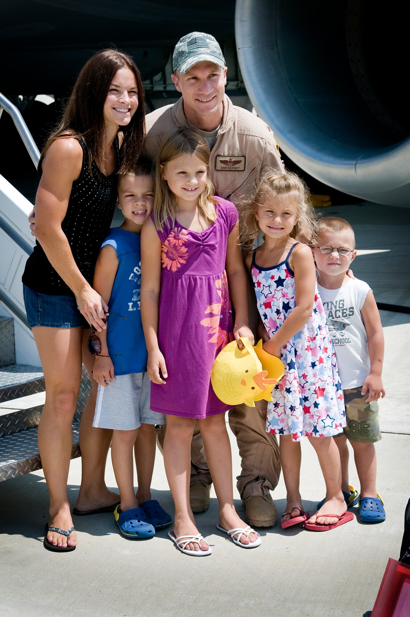 Maj. Dan Keeney, 74th Air Refueling Squadron KC-135R Stratotanker pilot, poses with his wife Paula, and children, from the left, Jonathan, Emily, Abby and Daniel, on the parking ramp July 21, 2013 upon his return to Grissom Air Reserve Base, Ind. Aircrew members were met by friends and family upon their return that day from a deployment to Southwest Asia. (U.S. Air Force photo/Tech. Sgt. Douglas Hays)