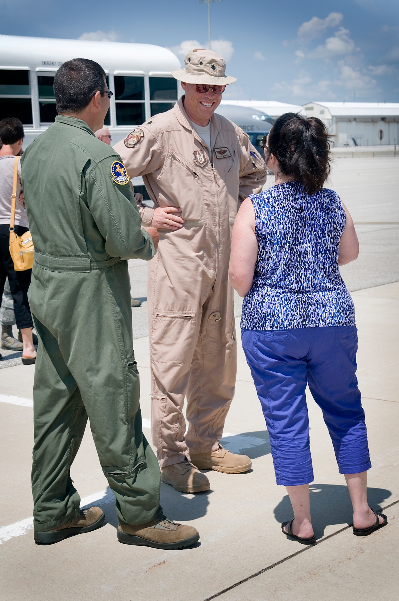 Lt. Col. Dave Marien, 434th Operations Support Squadron chief of standardization and evaluation, talks with his wife Dawn and Chief Master Sgt. Jeff Henry, 72nd Air Refueling Squadron chief boom, upon Marien's return to Grissom Air Reserve Base, Ind.,  July 21, 2013. Grissom aircrew members were rotating back from a deployment to Southwest Asia and were met by friends and loved ones. (U.S. Air Force photo/Tech. Sgt. Douglas Hays)