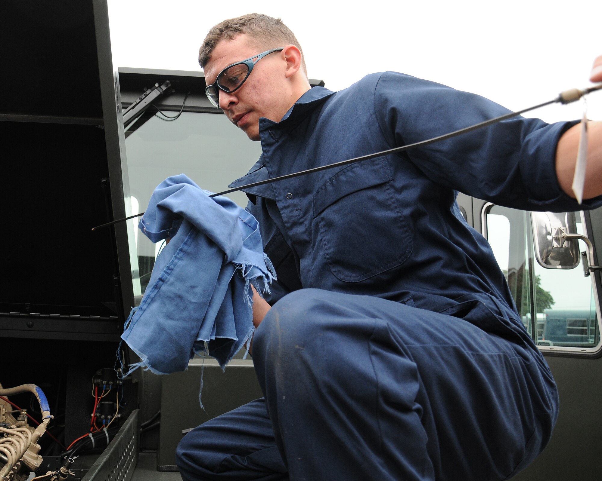 Airman Basic Jacob Rievel, 100th Logistics Readiness Squadron vehicle maintainer from Johnstown, Pa., checks the oil levels in the engine of an MB-4 Aircraft Tow Vehicle July 10, 2013, on RAF Mildenhall, England. The 100th LRS recently received a total of four MB-4s from the war reserve material center at Sanem Air Base in Luxembourg to support the 352nd Special Operations Group mission with the addition of the CV-22 Ospreys. (U.S. Air Force photo by Gina Randall/Released)
