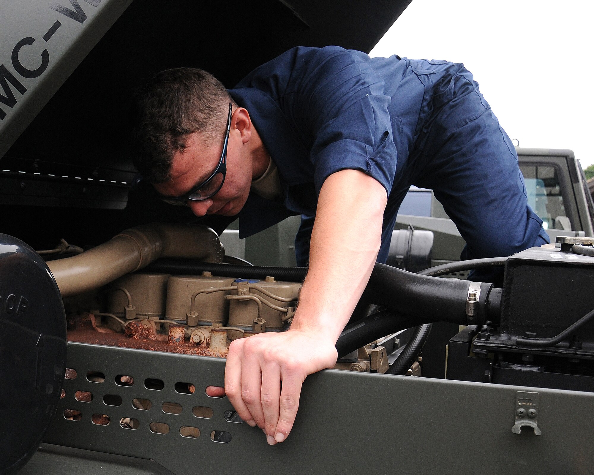Airman Basic Jacob Rievel, 100th Logistics Readiness Squadron vehicle maintainer from Johnstown, Pa.,  conducts a visual inspection of the engine of an MB-4 Aircraft Tow Vehicle July 10, 2013, on RAF Mildenhall, England. The 100th LRS recently received a total of four MB-4s from the war reserve material center at Sanem Air Base in Luxembourg to support the 352nd Special Operations Group mission with the addition of the CV-22 Ospreys. (U.S. Air Force photo by Gina Randall/Released)