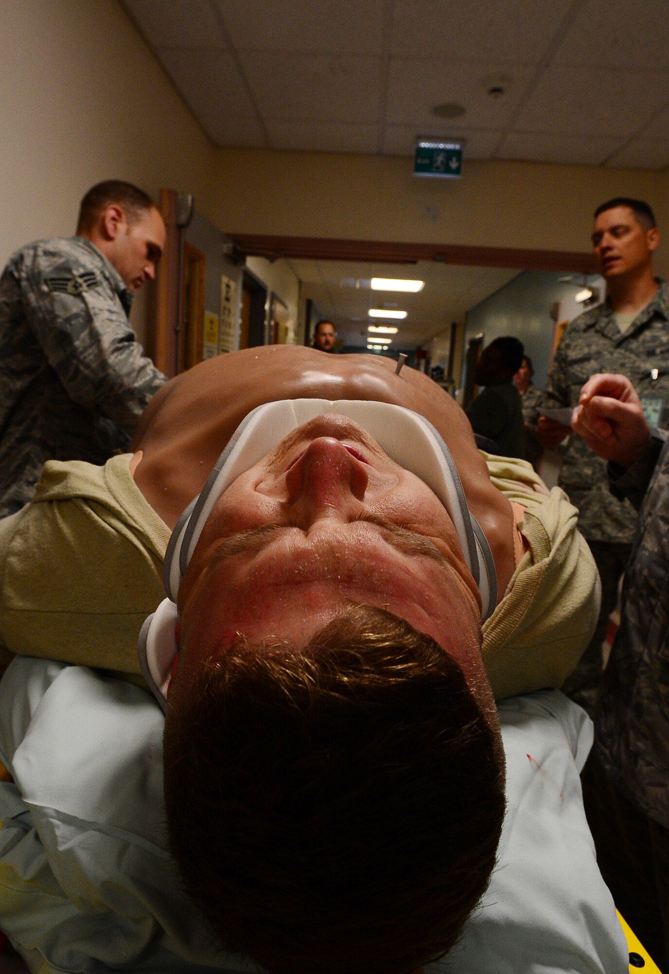 Staff Sgt. Matthew Kosemund, 48th Medical Group NCO in charge of medical simulations, awaits treatment during a car accident exercise at Royal Air Force Lakenheath, England, July 25, 2013. Liberty Airmen utilized various exercise scenarios to maintain readiness and increase proficiency and response time. (U.S. Air Force photo by Senior Airman Tiffany M. Grigg) 