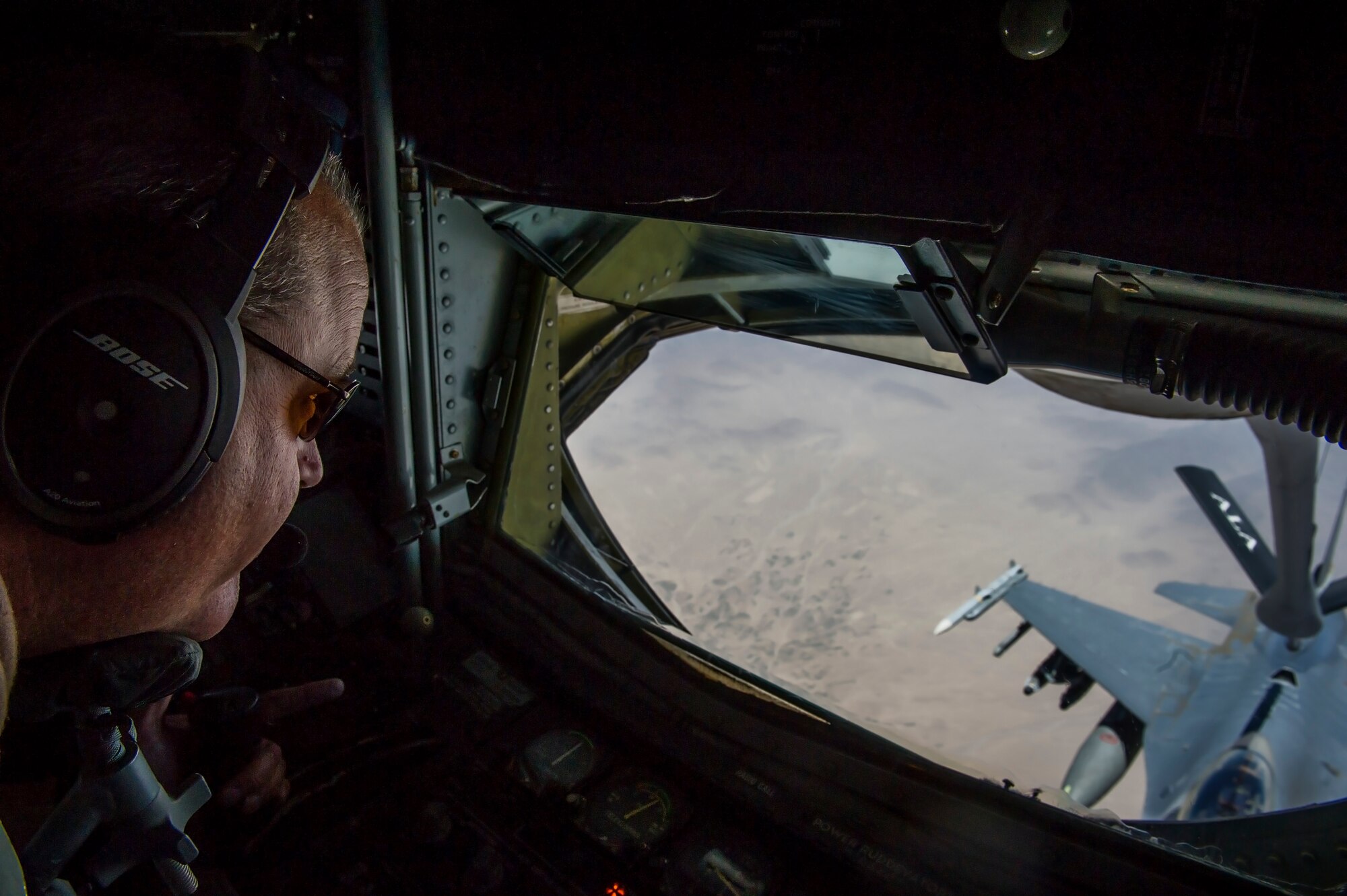 U.S. Air Force Senior Master Sgt. Bill Garrett, 340th Expeditionary Air Refueling Squadron KC-135 Stratotanker boom operator, controls the boom during an in-air refueling mission, July 17, 2013, over Afghanistan. The mission supported air operations in and around Afghanistan as part of Operation Enduring Freedom.  Garrett, a native of Phoenix, Ariz., is deployed from the Arizona Air National Guard, 161st Air Refueling Wing, Phoenix, Ariz. (U.S. Air Force photo/Staff Sgt. Marleah Miller)