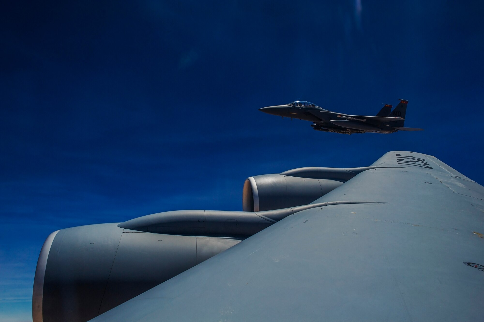 An F-15E Strike Eagle flies alongside a 340th Expeditionary Air Refueling Squadron KC-135 Stratotanker during an in-air refueling mission, July 17, 2013, over Afghanistan.  The mission supported air operations in and around Afghanistan as part of Operation Enduring Freedom. (U.S. Air Force photo/Staff Sgt. Marleah Miller)