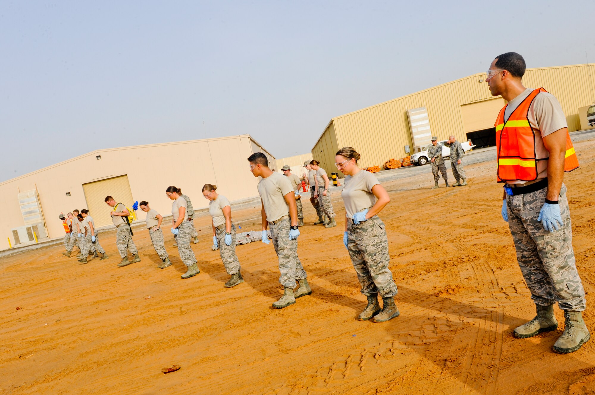 Airman from the 380th Expeditionary Force Support Squadron search and recovery team check their surrounding area for any possible finds during search and recovery training at an undisclosed location in Southwest Asia July 23, 2013.  The search line is kept as straight as possible to ensure that no item will be overlooked. (U.S. Air Force photo by Staff Sgt. Joshua J. Garcia)