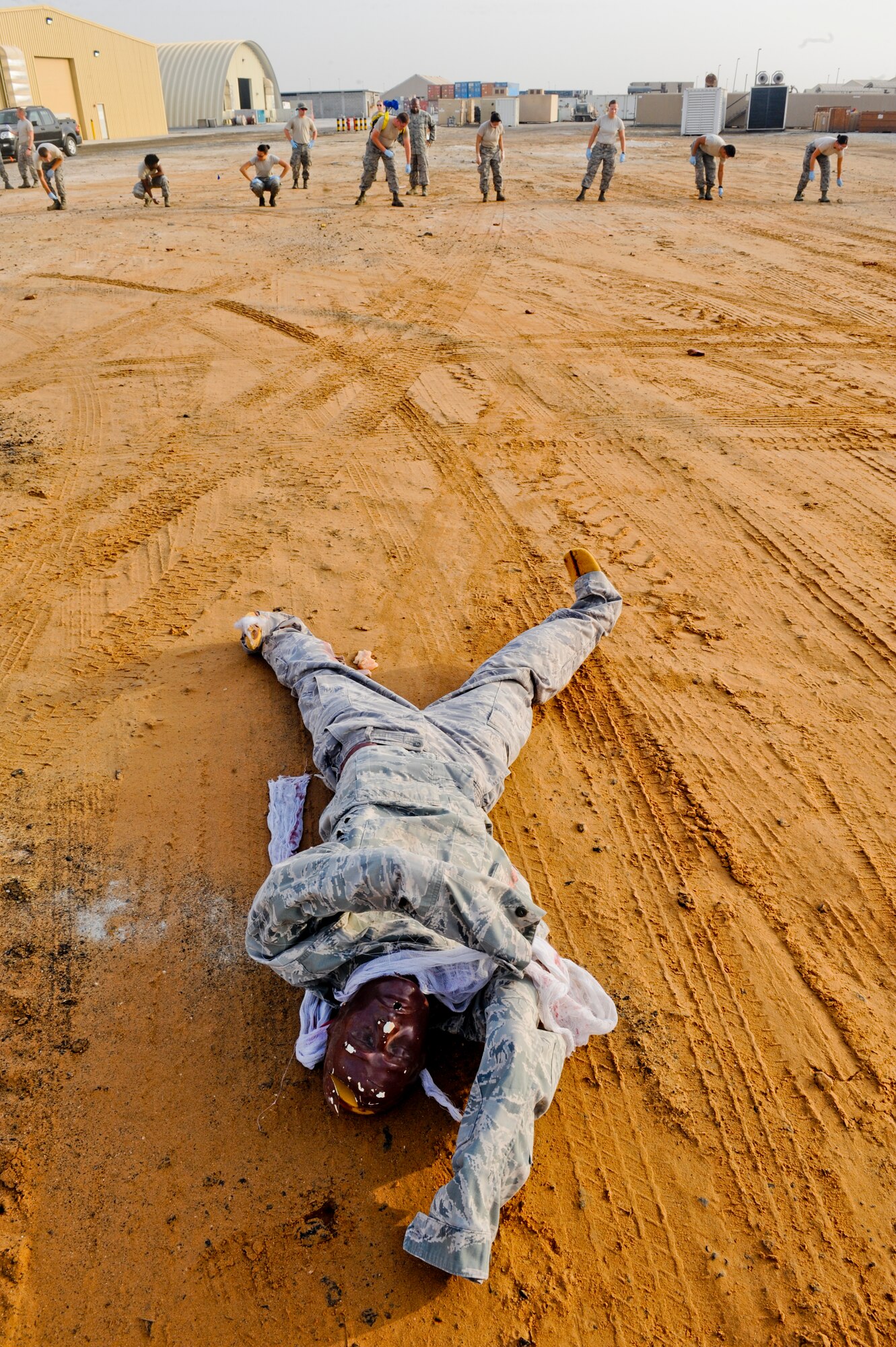 A simulated casualty waits to be located Airmen of the 380th Expeditionary Force Support Squadron during search and recovery training at an undiscovered location in Southwest Asia July 23, 2013.  Even though the casualty is in plain sight it cannot be marked as “found” until it’s within arm’s reach of the search and recovery line, this ensures that no possible items are overlooked. (U.S. Air Force photo by Staff Sgt. Joshua J. Garcia)  