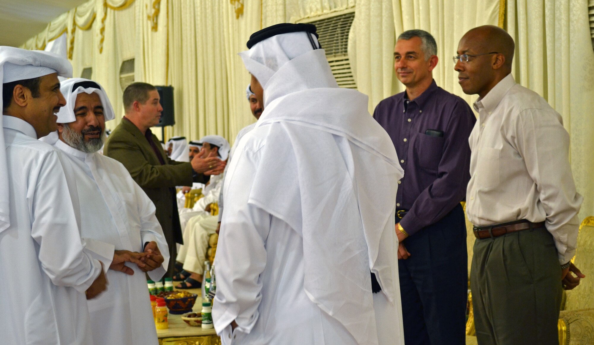 Local military leaders socialize before the start of an Iftar dinner base leadership was invited to participate in Southwest Asia, July 21, 2013. Iftar means "to break fast," and refers to the evening meal after sunset when Muslims break their fast during the Islamic month of Ramadan. At approximately 6:30 p.m., just as the sun sets, the ‘Call to Prayer’ occurs, signaling the breaking of the fast. (U.S. Air Force photo/Lt. Col. Craig Punches)