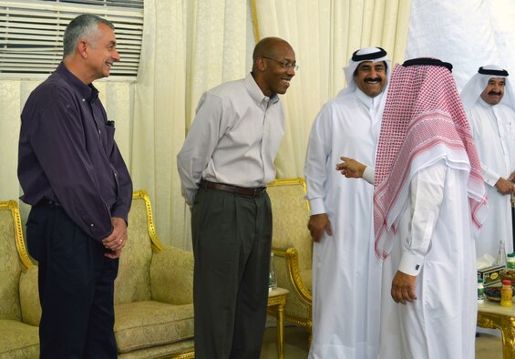 Brig. Gen. Roger Watkins (left) and Maj. Gen. Charles Brown (right) converse with local military leaders during an Iftar dinner base leadership was invited to participate in Southwest Asia, July, 21, 2013. Iftar means "to break fast," and refers to the evening meal after sunset when Muslims break their fast during the Islamic month of Ramadan. Watkins is the 379th Air Expeditionary Wing commander and Brown is the Deputy Combined Force Air Component Commander. (U.S. Air Force photo/Lt. Col. Craig Punches)