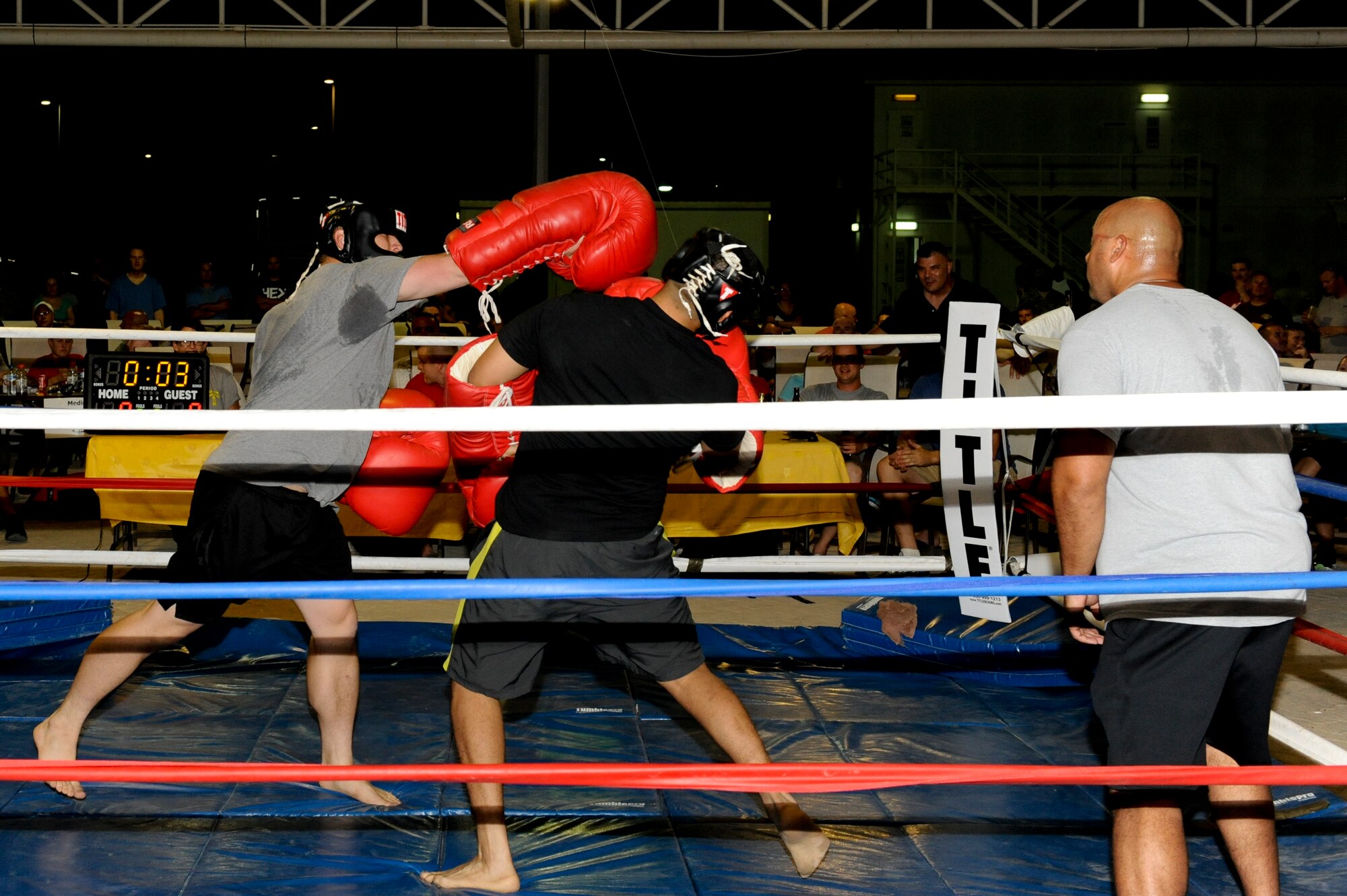 U.S. Air Force Staff Sgt. Jeremiah Waychoff, 380th Expeditionary Logistic Readiness Squadron, hits U.S. Airman 1st Class Geovanni Nunez, 380th ELRS, with a straight right during their big gloves boxing match at an undisclosed location in Southwest Asia July 19, 2013.  The boxing event consisted of six fights. Waychoff is deployed from Joint Base McGuire-Dix-Lakehurst, N.J., and Nunez is deployed from Eielson Air Force Base, Alaska. (U.S. Air Force photo by Staff Sgt. Joshua J. Garcia)