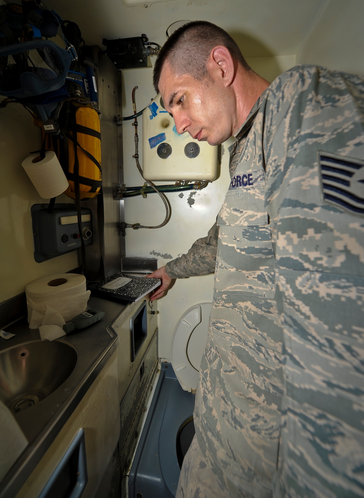 Tech. Sgt. Christopher Breski inspects the restroom on a C-17 Globemaster III to prepare it for its next mission at the 379th Air Expeditionary Wing in Southwest Asia, July 22, 2013. Breski is the 8th Expeditionary Air Mobility Squadron fleet services NCO in charge deployed from Joint Base McGuire-Dix-Lakehurst, N.J. (U.S. Air Force photo/Senior Airman Benjamin Stratton)