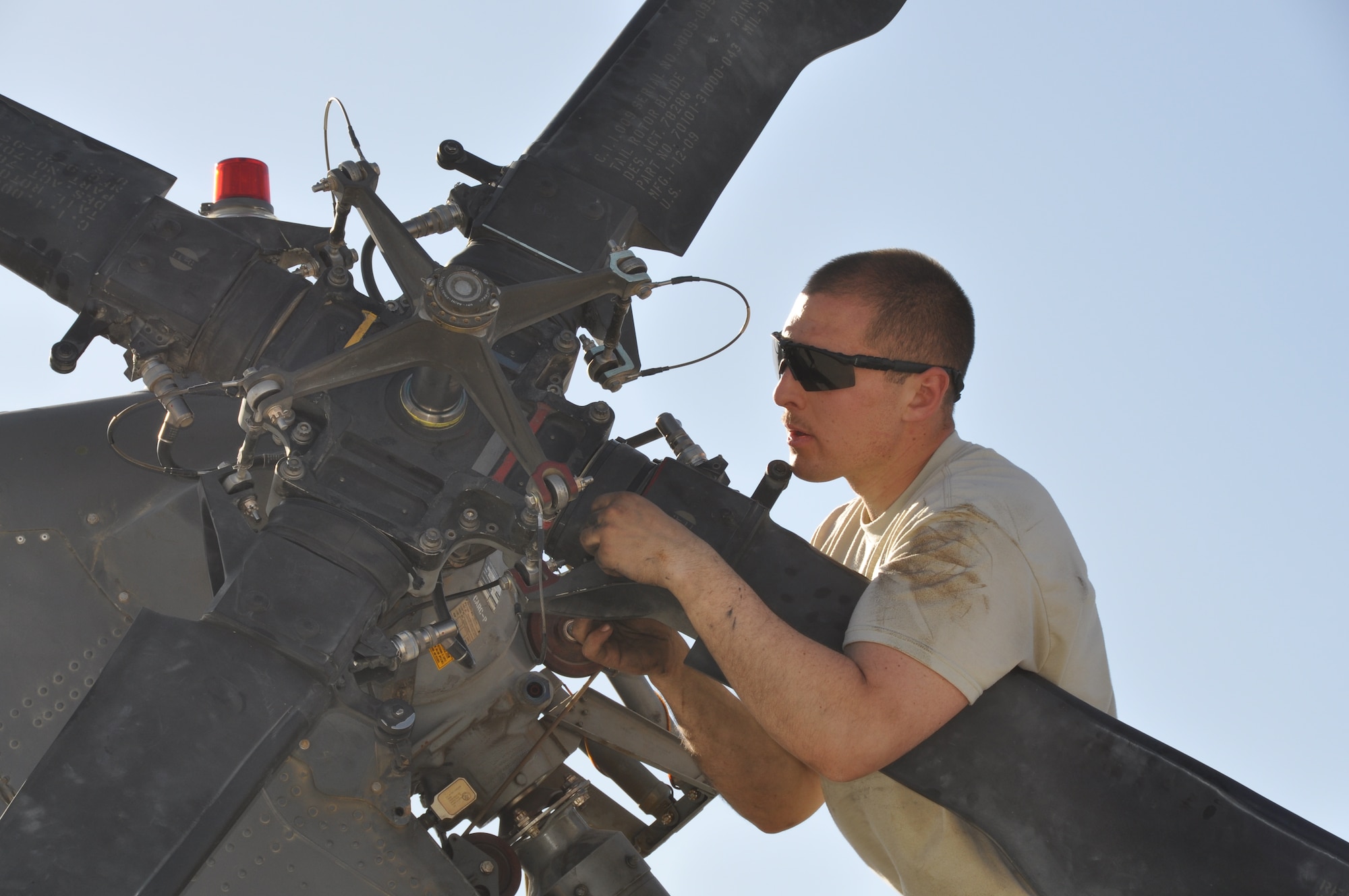 Airman 1st Class Andrew Willard, 455th Expeditionary Maintenance Squadron electronic warfare craftsmen assistant, helps conduct a 50-hour preventative maintenance inspection on aircraft 89-6205, an HH-60G Pave Hawk helicopter assigned to the 56th Expeditionary Helicopter Maintenance Unit at Bagram Air Field, Afghanistan, July 24, 2013. The helo achieved the coveted black-letter initial exceptional release July 23, 2013, for the first time in the unit since 2005. After the ER was signed, the HH-60 launched as part of a mission attributed to saving two lives later the same day. Aircraft 89-6205 happens to be the same aircraft that attained the status for the unit eight years ago. (U.S. Air Force photo/Tech. Sgt. Rob Hazelett) 

