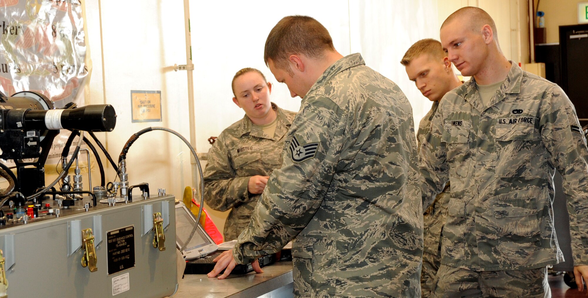 U.S. Air Force precision guided munitions Airmen with the 35th Maintenance Squadron, review their technical order during an AIM-9 Sidewinder missile inspection at Misawa Air Base, Japan, July 26, 2013. Inspections on the Sidewinder missile are required every five years. (U.S. Air Force photo by Airman 1st Class Kenna Jackson)