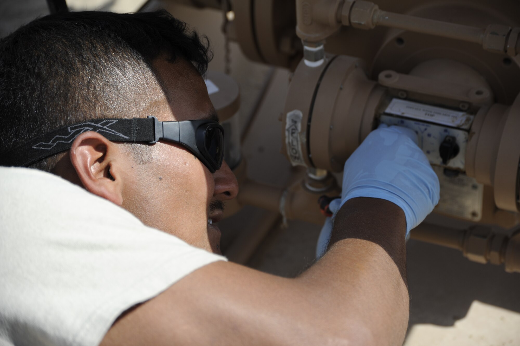Senior Airman Jesse Silva, 386th Expeditionary Logistics Readiness Squadron, bulk storage attendant, adjusts the knobs on a Hammonds Additive Injector here, July 16, 2013.  Silva does this to regulate how much additive is injected into the fuel, the squadron’s first delivery of Jet A1. The 386th Air Expeditionary Wing has joined a list of many other Air Force units making the switch from JP8, military specification fuel, to commercial fuel.  In order to prepare the Jet A1 fuel for use in military aircraft, Silver overseas the injection of two additives, the fuels system icing inhibitor to help prevent water in the fuel from freezing and the corrosion inhibitor/lubricity improver.  Silva is deployed out of the Atlantic City, N.J., Air National Guard unit.  (U.S. Air Force photo by Master Sgt. Christopher A. Campbell)