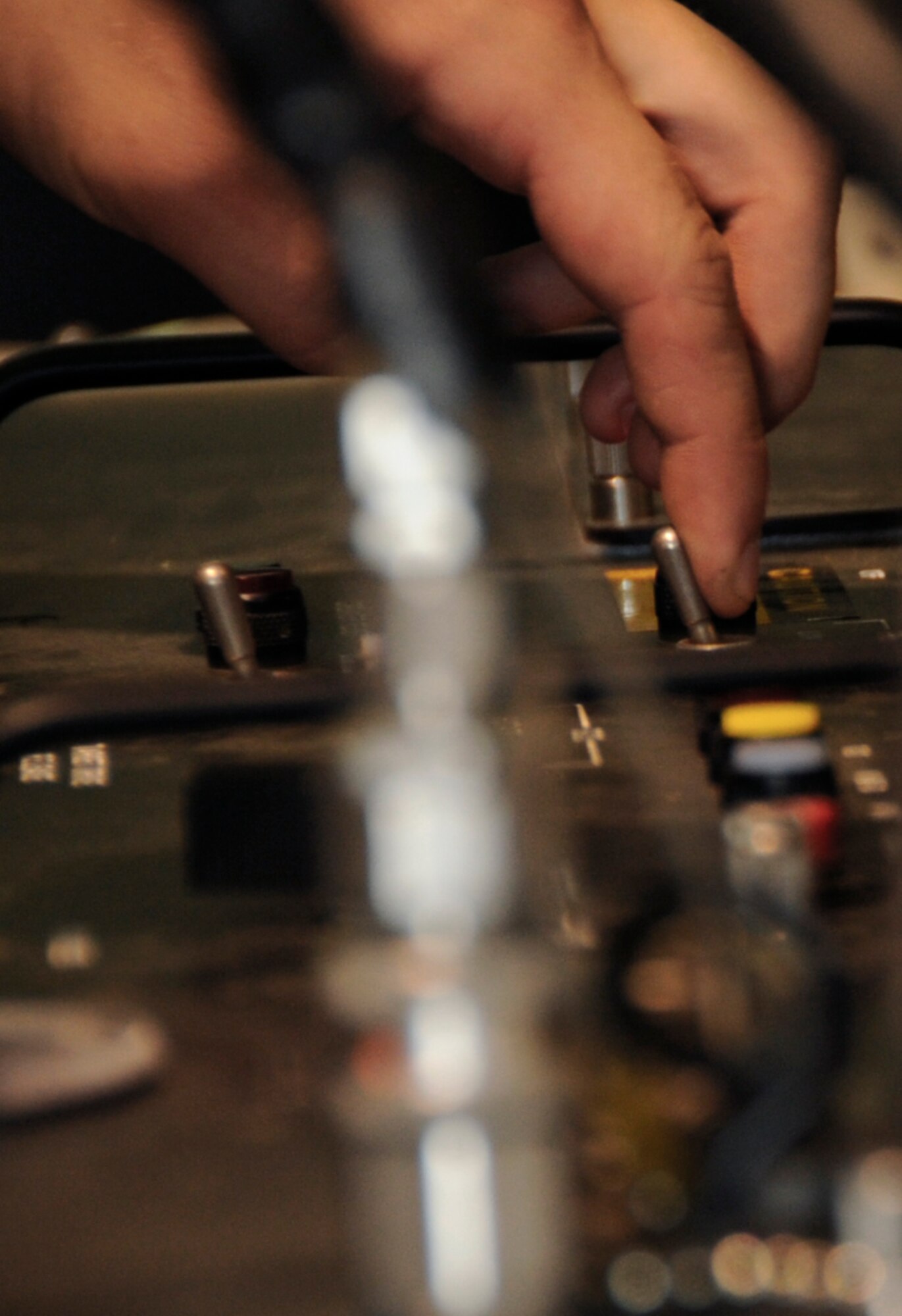U.S. Air Force Airman 1st Class Joshua Beadle, 35th Maintenance Squadron precision guided munitions crew chief, checks the controls of a guidance control section unit test set at Misawa Air Base, Japan, July 26, 2013. More than 20 checks are preformed to make sure the GCS is ready for use before the inspection of an AIM-9 Sidewinder missile. (U.S. Air Force photo by Airman 1st Class Kenna Jackson)
