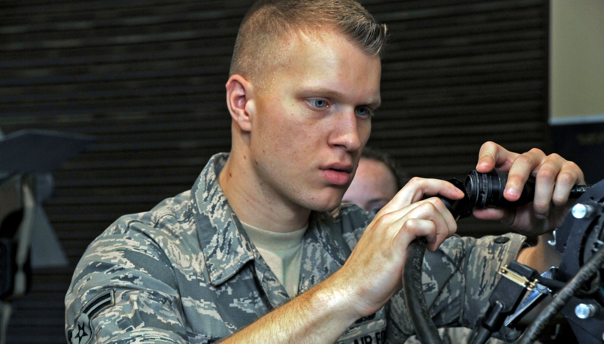 U.S. Air Force Airman 1st Class Joshua Beadle, 35th Maintenance Squadron precision guided munitions crew chief, plugs a guidance control section unit test set into a wall at Misawa Air Base, Japan, July 26, 2013. Of the several parts that make up a missile, the “head” is the only part tested with the GCS unit. (U.S. Air Force photo by Airman 1st Class Kenna Jackson)