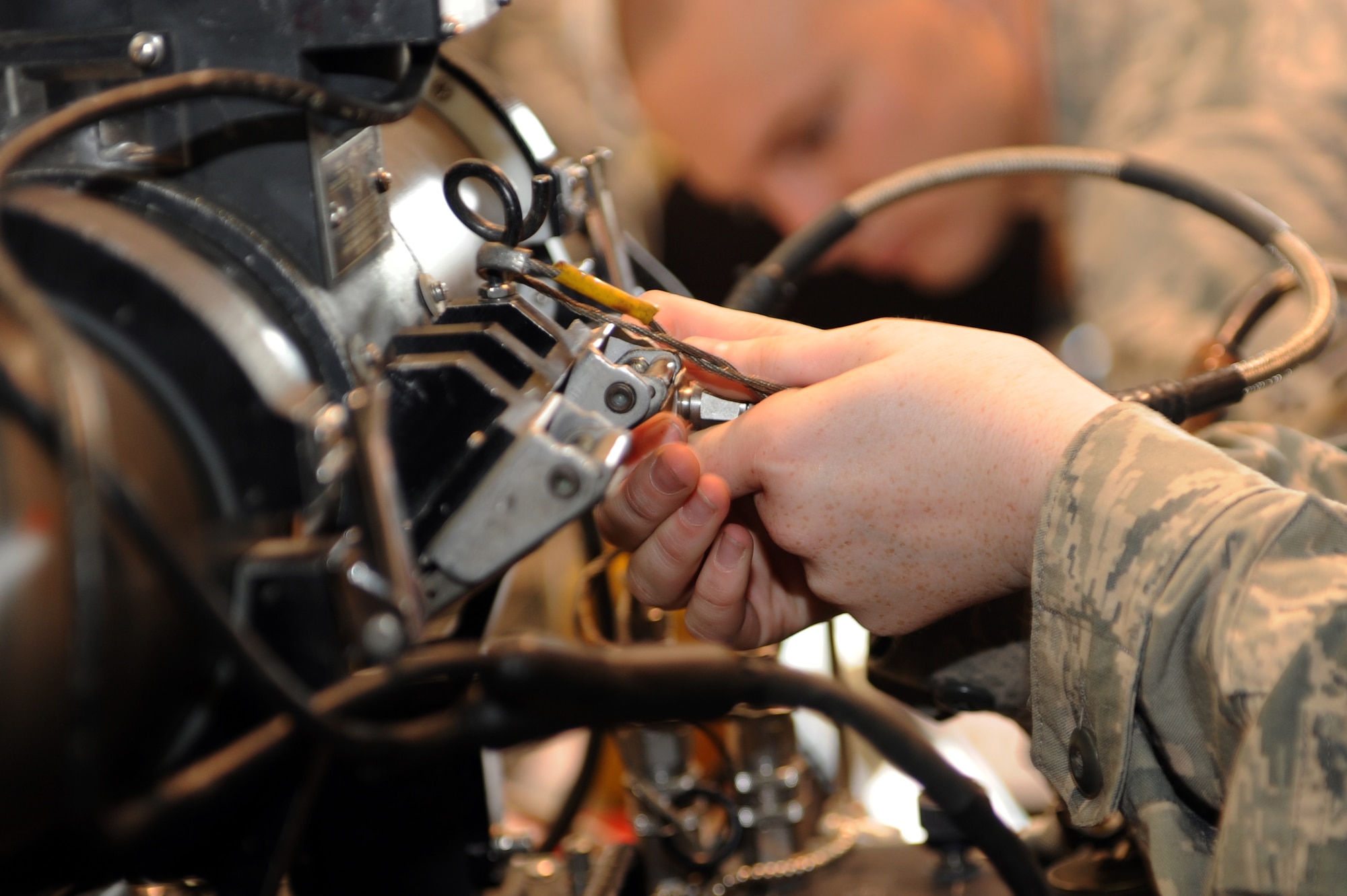 U.S. Air Force Airman Nicole Whisted, 35th Maintenance Squadron precision guided munitions crew member, plugs in an air pressure tube to a guidance control section unit test set at Misawa Air Base, Japan, July 26, 2013. Air pressure is used in several different tests that are preformed on a missile to validate its mission readiness. (U.S. Air Force photo by Airman 1st Class Kia Atkins)