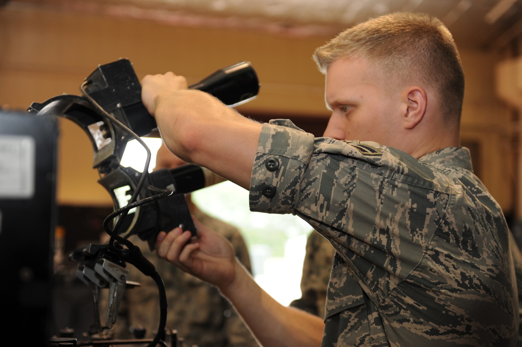 U.S. Air Force Airman 1st Class Joshua Beadle, 35th Maintenance Squadron precision guided munitions crew chief, puts a torque measurement assembly on an AIM-9 Sidewinder at Misawa Air Base, Japan, July 26, 2013. Although there are several parts that make up the missile, the “head” is the only part tested with the guidance control section unit test set. (U.S. Air Force photo by Airman 1st Class Kia Atkins)