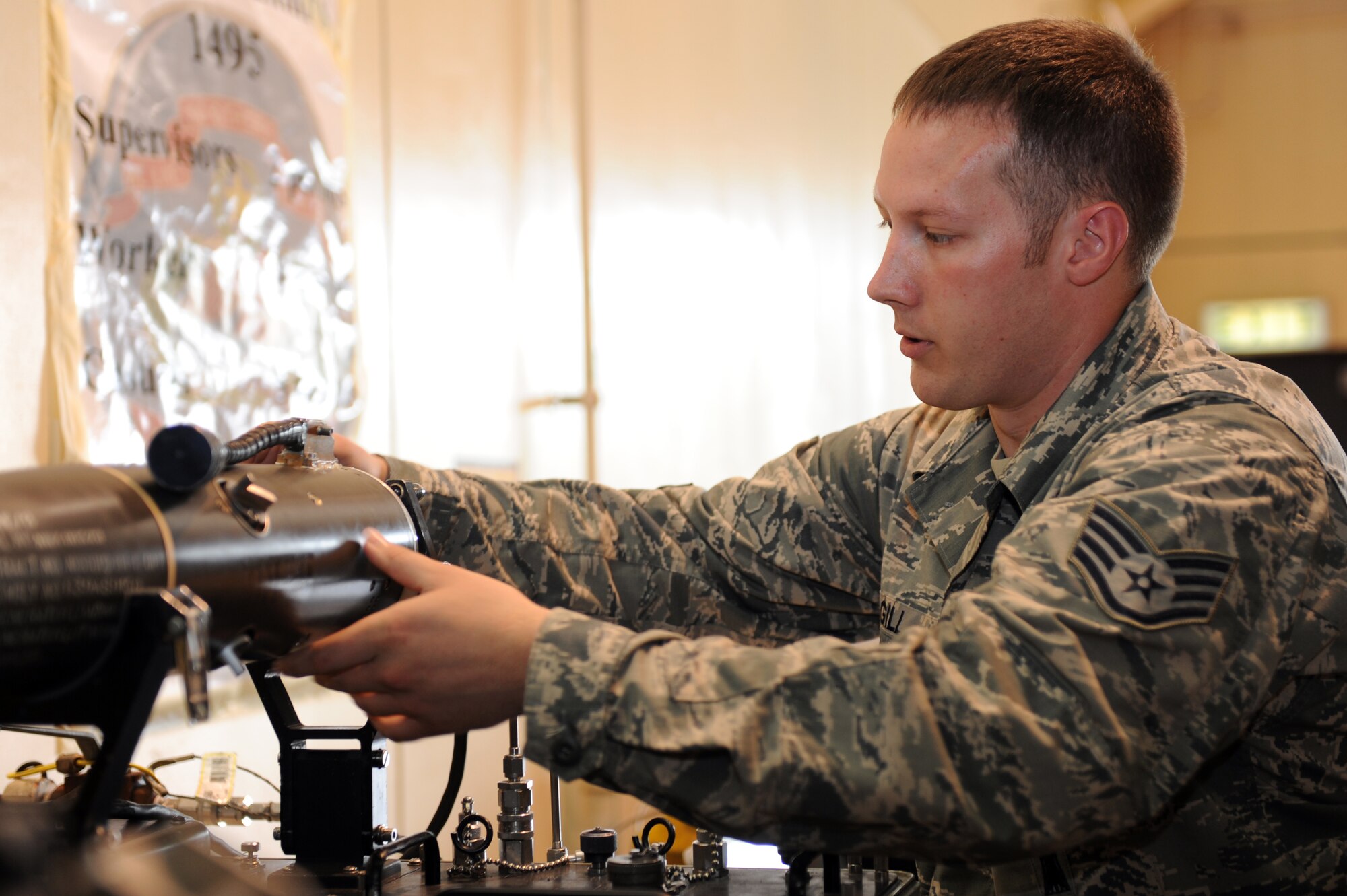 U.S. Air Force Staff Sgt. James Gill, 35th Maintenance Squadron precision guided munitions crew chief, adjusts an AIM-9 Sidewinder to the guidance control section unit test set at Misawa Air Base, Japan, July 26, 2013. More than 50 checks are performed during this inspection and each one is mandatory to validate the missile’s mission readiness. (U.S. Air Force photo by Airman 1st Class Kia Atkins)
