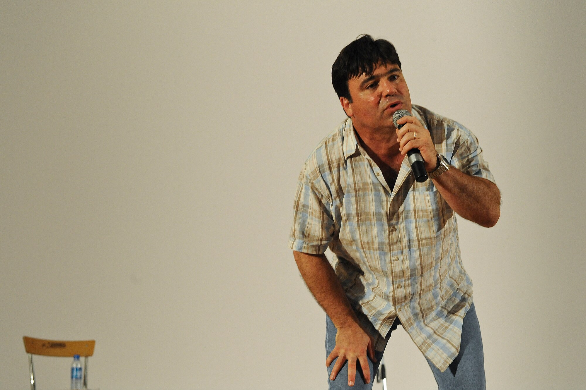 “I have to apologize, I sweat a lot.”  
Comedian Sam Fedele leans in for emphasis during his performance at an undisclosed location in Southwest Asia, Saturday, July 20, 2013.  
 “I have a medical condition… I’m fat.”  (U.S. Air Force Photo by 1st Lt. Nathan Wallin)
