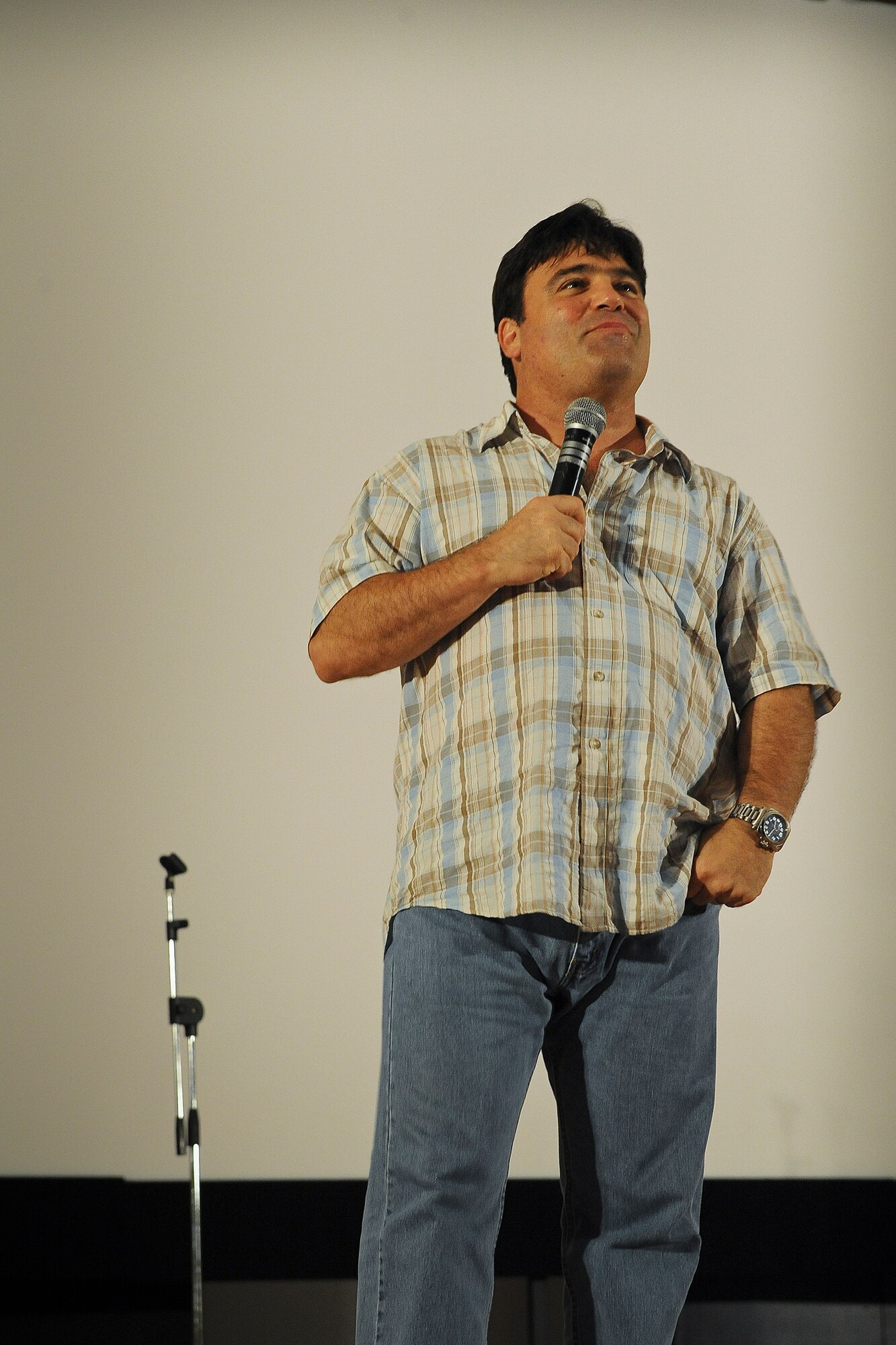 Comedian Sam Fedele basks in the laughter after a joke about family life gets a big laugh during his routine for the deployed men and women.  
“My wife didn’t give birth to daughters, my wife gave birth to reinforcements,” he said.  (U.S. Air Force Photo by 1st Lt. Nathan Wallin)
