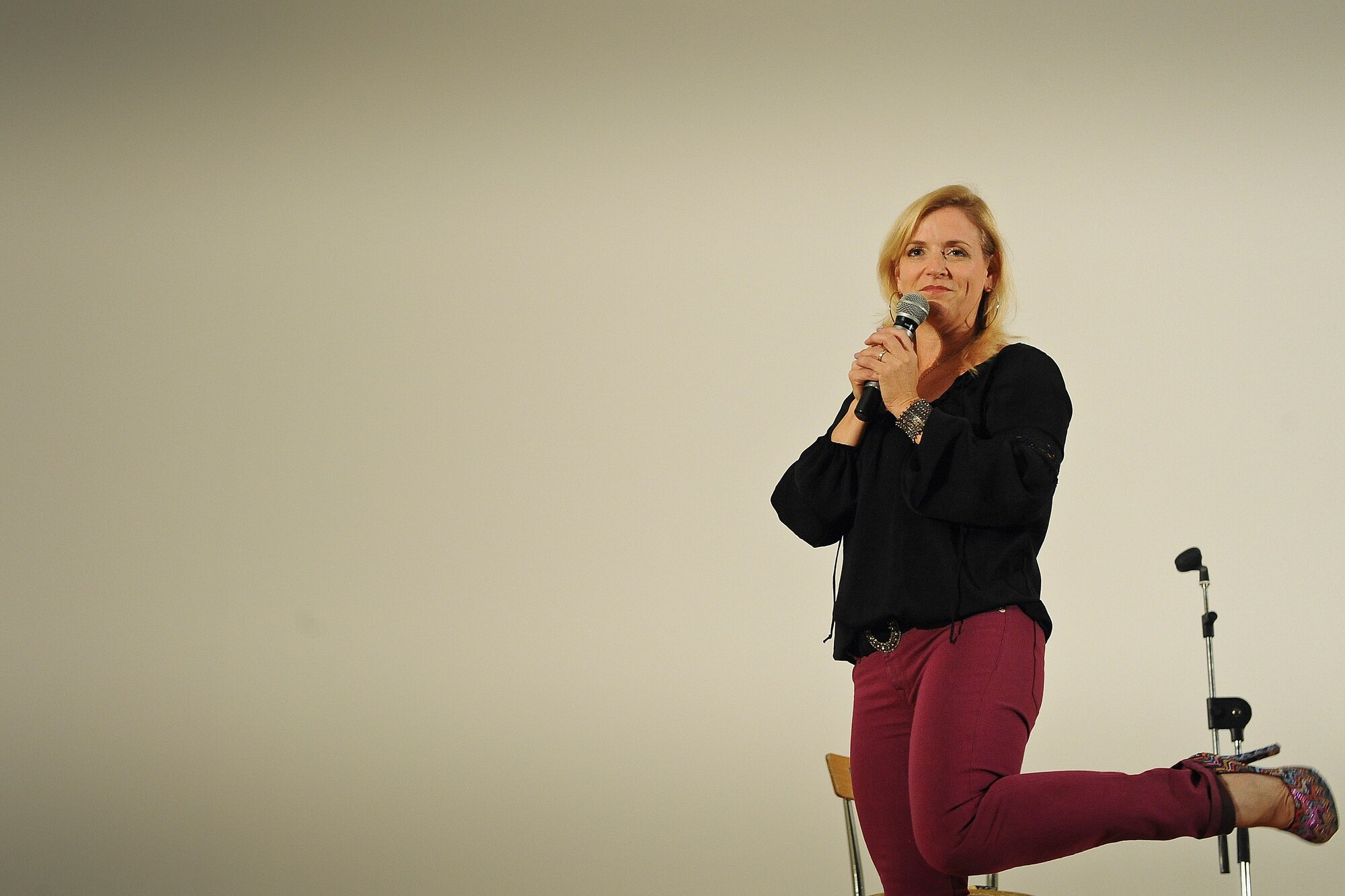 Comedienne Laura Hayden models her purple heels for the men and women of the 386th Air Expeditionary Wing Saturday, July 20, 2013.  (U.S. Air Force Photo by 1st Lt. Nathan Wallin)