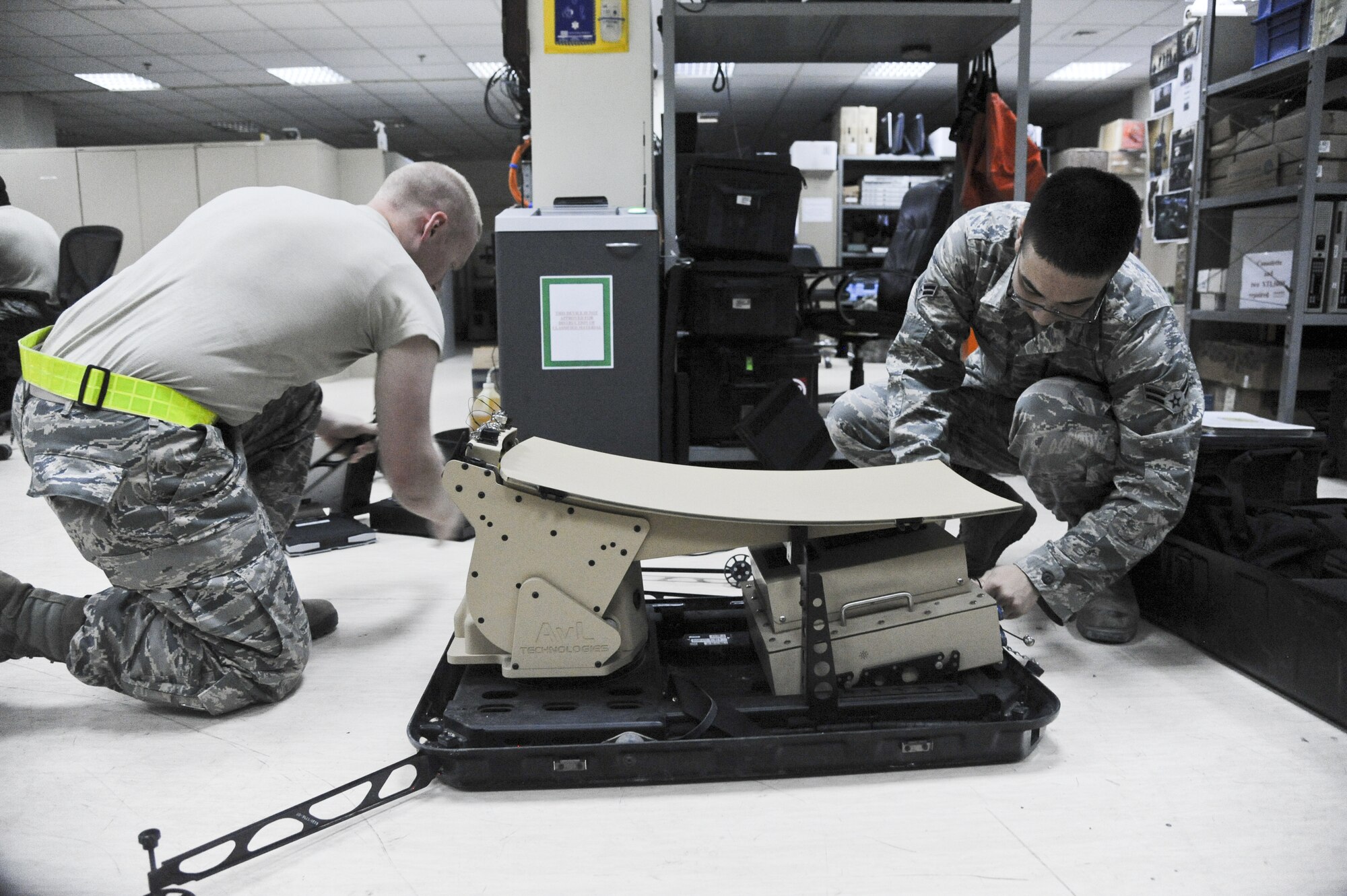 U.S. Air Force Staff Sgt. Daniel Johnson, left, 380th Expeditionary Communications Squadron radio frequency transmissions supervisor and Airman 1st Class Steven Hamm, 380th ECS radio frequency transmissions journeyman, set up a mobile satelitte communications kit at an undisclosed location in Southwest Asia July 23, 2013. These Airmen are setting a kit that is used for setting up internet and telephone services just about anywhere in the world. Johnson calls Port Orchard, Wash., home and is deployed from Camp Zama, Japan. Hamm is from Aurora, Colo., and is deployed from Kapaun Air Station, Germany. (U.S. Air Force photo by Senior Airman Jacob Morgan)