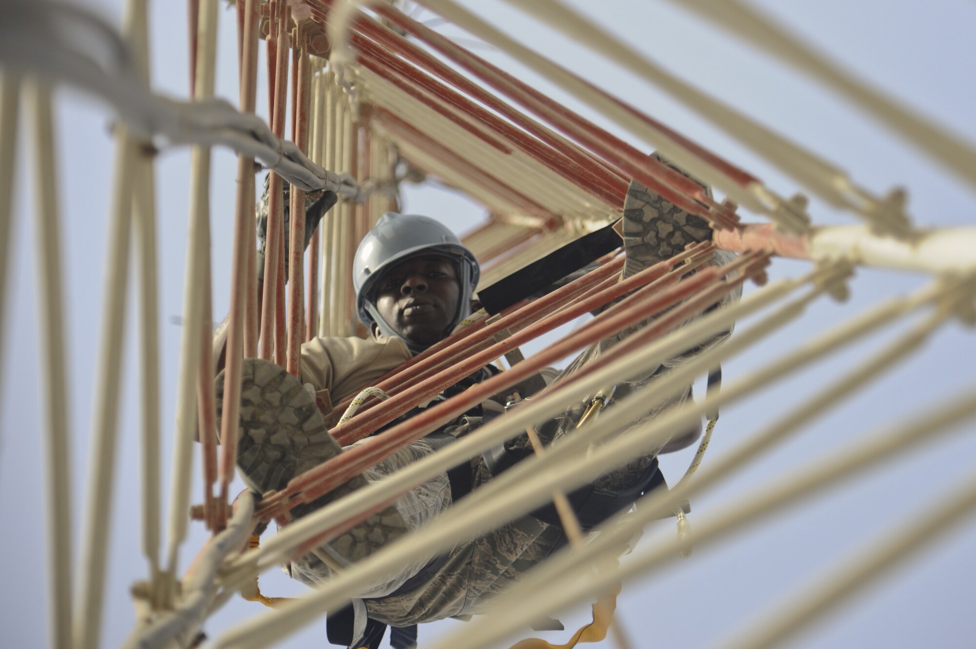 U.S. Air Force Staff Sgt. Jonathon Hobson, 380th Expeditionary Communications Squadron radio frequency transmissions supervisor, climbs a radio tower designed to hold multiple antennae at an undisclosed location in Southwest Asia July 23, 2013. The radio frequency shop maintains all equipment and proccesses using radio frequency to communicate, which encompasses more than 3,000 pieces of equipment and several different jobs. Hobson calls Join Base Lewis-McChord, Wash., home and is deployed from Schriever Air Force Base, Colo. (U.S. Air Force photo by Senior Airman Jacob Morgan)