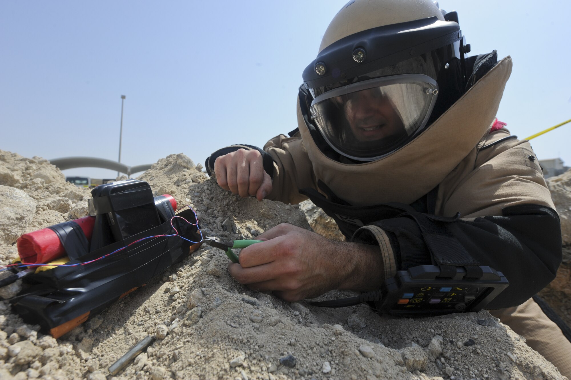 U.S. Air Force Staff Sgt. Andrew Roberts, 380th Expeditionary Civil Engineer Squadron explosive ordnance disposal technician, disables a training improvised explosive device at an undisclosed location in Southwest Asia July 25, 2013. The 380th Air Expeditionary Wing EOD team is responsible for disabling conventional munitions and IEDs. Roberts calls Blanchard, Idaho, home and is deployed from Fairchild Air Force Base, Wash. (U.S. Air Force photo by Senior Airman Jacob Morgan)