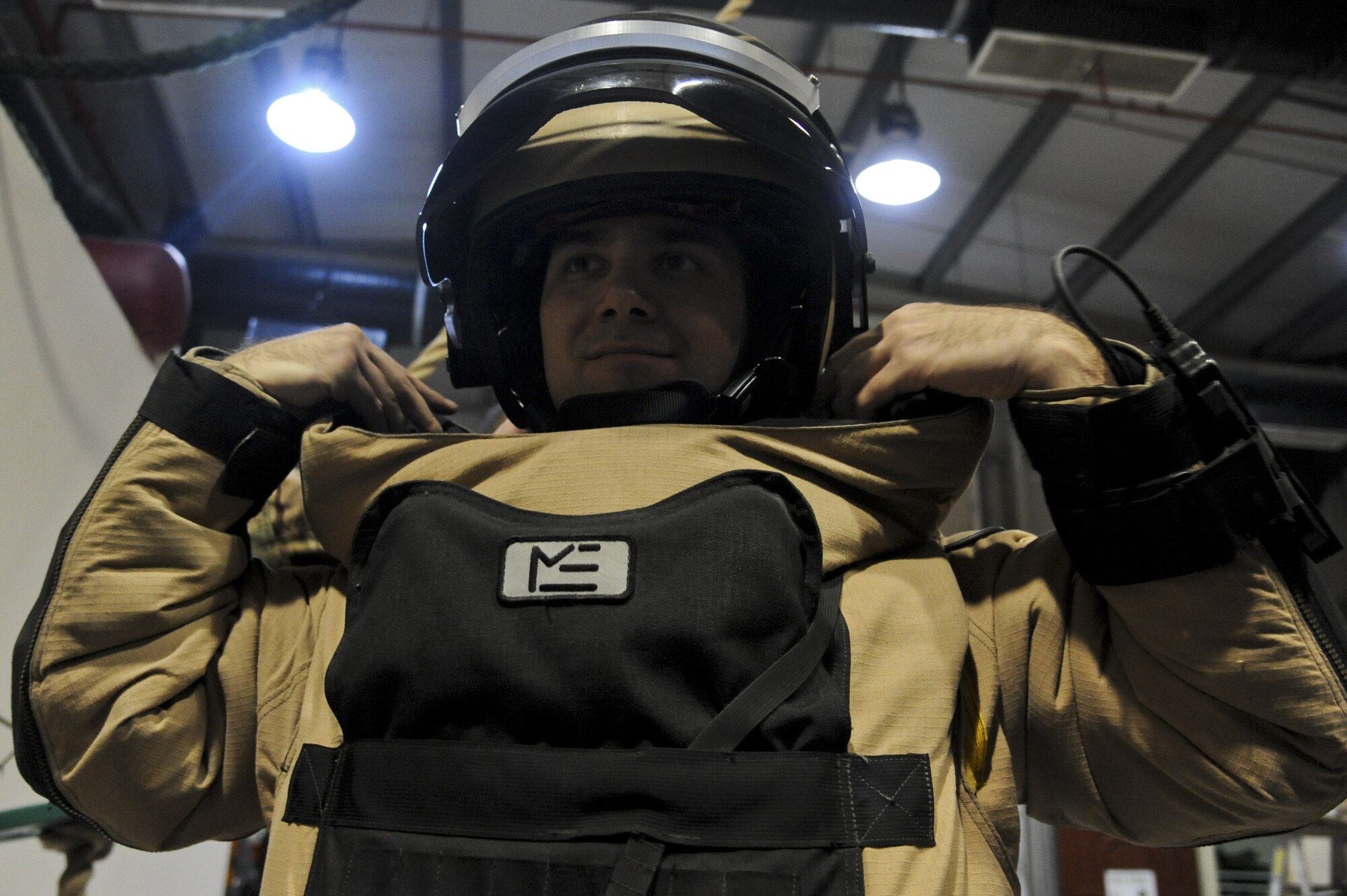 U.S. Air Force Staff Sgt. Andrew Roberts, 380th Expeditionary Civil Engineer Squadron explosive ordnance disposal technician, puts on a bomb suit at an undisclosed location in Southwest Asia July 25, 2013. Roberts was getting ready for a training mission to find and disable a training improvised explosive device. Roberts calls Blanchard, Idaho, home and is deployed from Fairchild Air Force Base, Wash. (U.S. Air Force photo by Senior Airman Jacob Morgan)