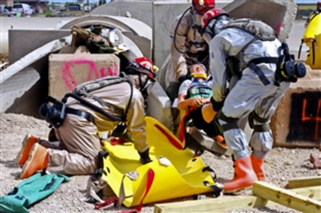 Soldiers and airmen move a simulated patient as part of a process to get certified for a chemical, biological, radiological and nuclear-enhanced response force during 2013 Vigilant Guard in Adams County, Colo., July 19, 2013. The certification mission is to search, extract, chemically decontaminate and provide first-line medical care to civilian victims of a large-scale disaster.