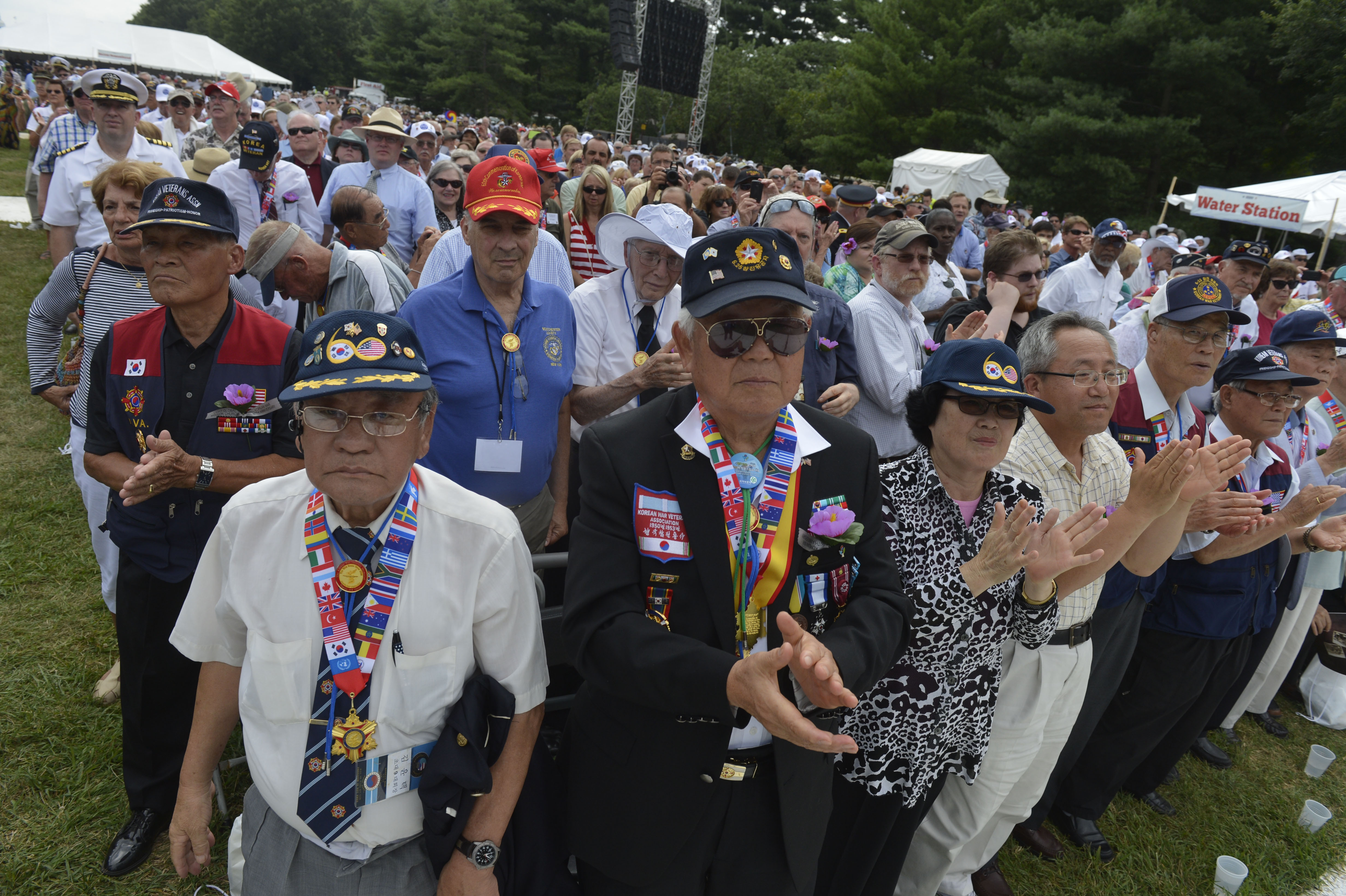 Attendees applaud as President Barack Obama and Defense Chuck Hagel