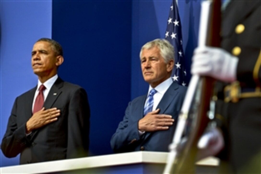President Barack Obama and Defense Secretary Chuck Hagel render honors during the playing of the national anthem as they mark the 60th anniversary of the armistice ending the Korean War at the Korean War Memorial in Washington, D.C., July 27, 2013.