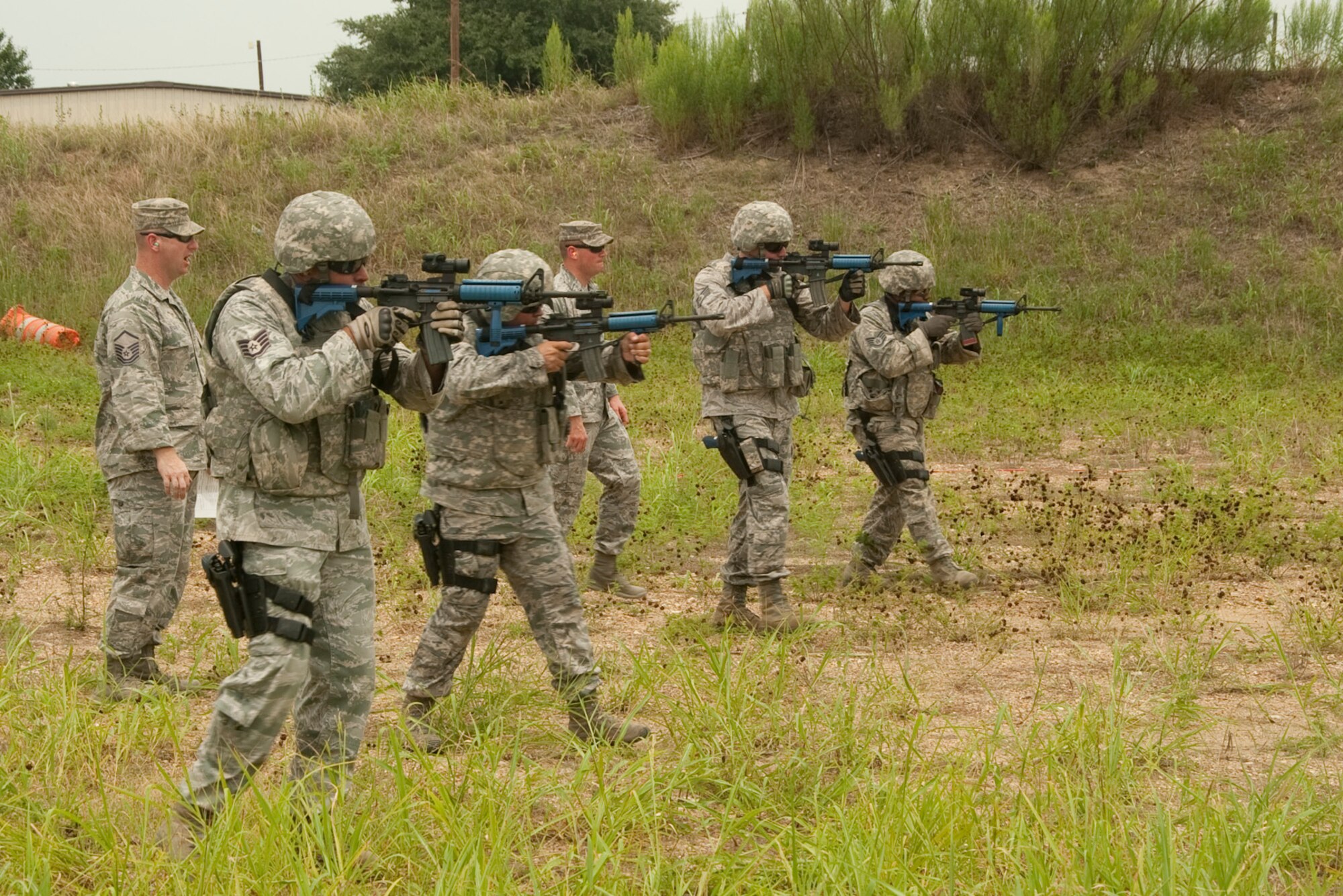 U.S. Air National Guard Security Forces from the 136th Airlift Wing practice their shoot and move maneuvers at Naval Air Station Fort Worth Joint Reserve Base, Texas, July 28, 2013. The practice allows them to simulate real world scenarios for deployments. (Air National Guard photo by Airman Cody Witsaman / released)