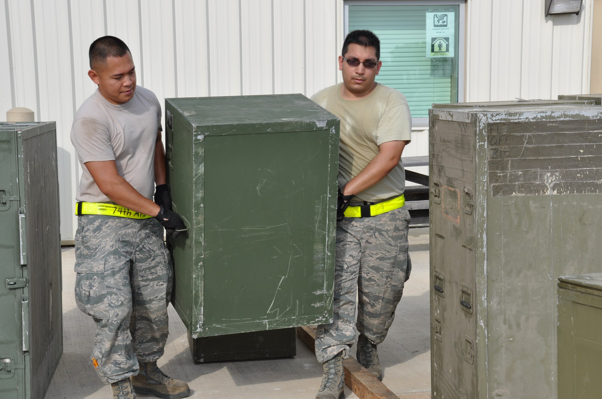Senior Airmen Jeff Perez (left) and Rudy Villalobos, 74th Aerial Porter Squadron,  prepare cargo for shipment during a Compliance Inspection on July 27. The IG spent a week at the 433rd Airlift Wing to inspect the wing’s readiness to airlift and provide combat ready forces. (Air Force photo by Tech Sgt. Carlos J. Trevino)
