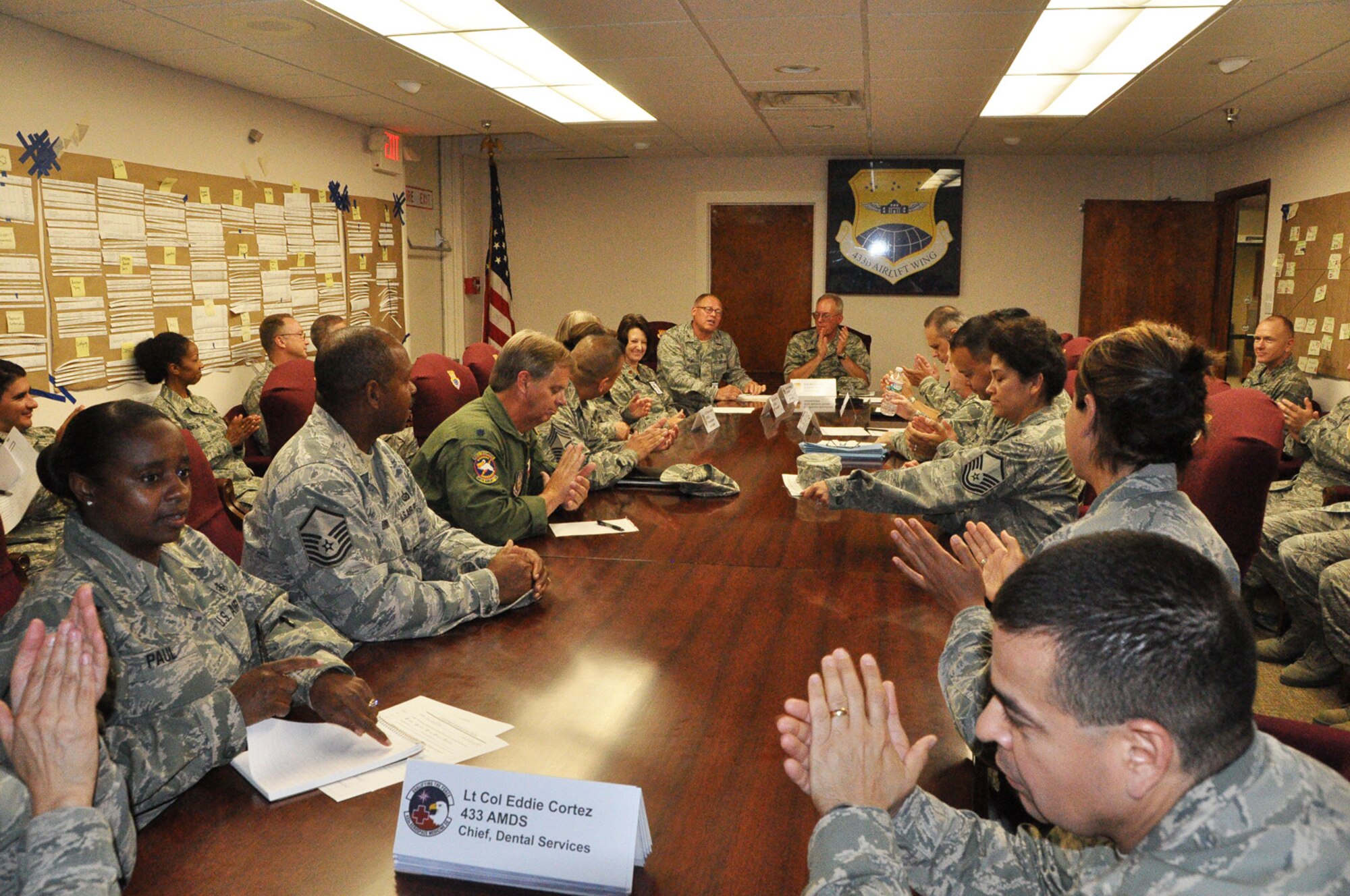 Members of the 433rd Airlift Wing Medical Group cheer with hoots and hollers as they are told their Health Services Inspection held over the July 27-28 Unit Training Assembly weekend at Joint Base San Antonio-Lackland is complete. An HSI is an inspection to ensure medical groups are in compliance with Air Force Standards. (U.S. Air Force photo by 1st Lt. Denise Haeussler)