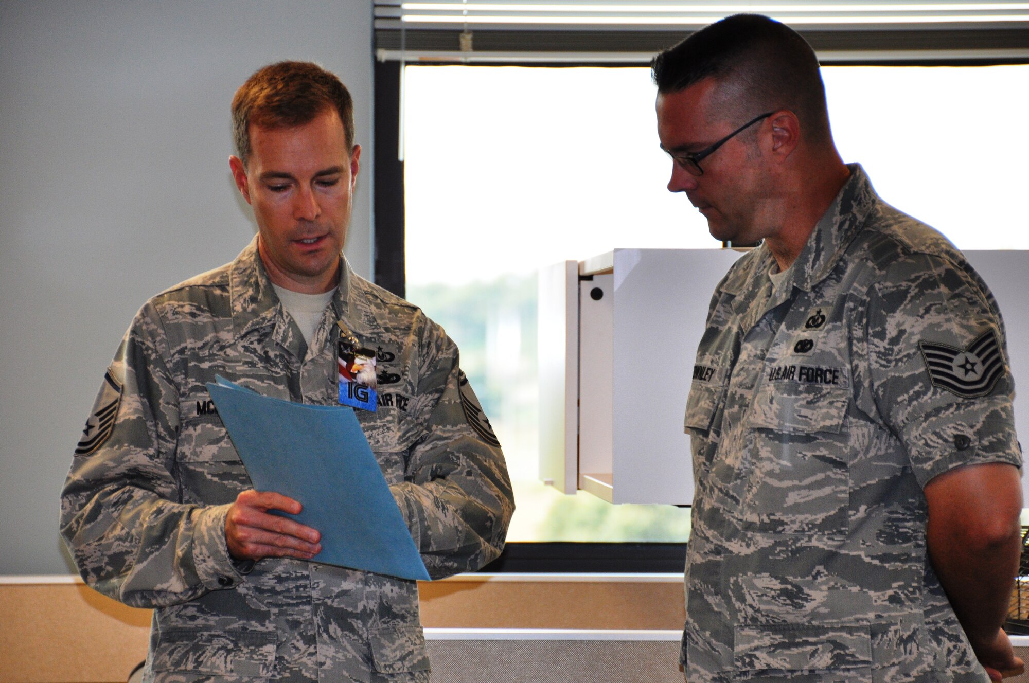 Master Sgt. Brian McDowell, Air Force Reserve Command Inspector General, reviews his findings with Tech Sgt. Neil Townley, 433rd Safety Office, during a Compliance Inspection on July 27 at the 433rd Airlift Wing.  The IG spent a week at the 433rd to inspect the wing’s readiness to provide combat ready forces. (Air Force photo by Tech Sgt. Carlos J. Trevino)
