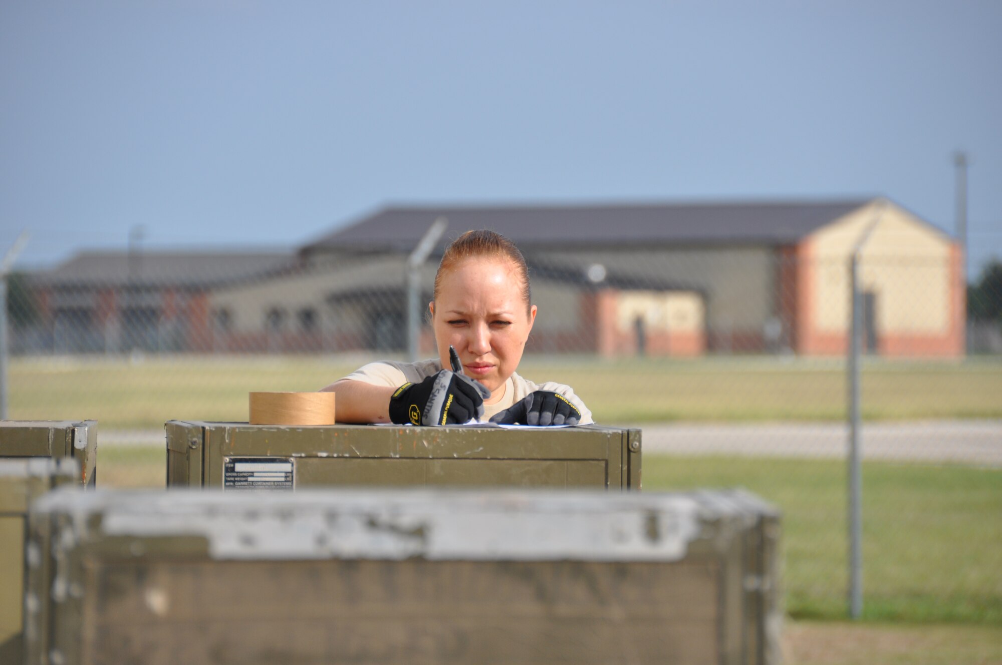 Airman 1st Class Sandra Santos, 74th Aerial Porter Squadron, writes an inventory of equipment to be airlifted.  On July 27 Santos and her fellow porters demonstrated their proficiency during a Compliance Inspection. (Air Force photo by Tech Sgt. Carlos J. Trevino)