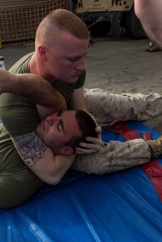 U.S. Marine Corps Lance Cpl. William Phillips, top, bulk fuel specialist from Bryson City, N.C., assigned to Combat Logistics Battalion 26, 26th Marine Expeditionary Unit (MEU), demonstrates a Marine Corps Martial Arts Program (MCMAP) technique on Lance Cpl. Jordan Leitson, tank driver from West Bloomfield, Mich., assigned to Battalion Landing Team 3/2, 26th MEU, as they test for their brown belts in MCMAP on the boat deck of the USS Carter Hall (LSD 50), at sea, July 27, 2013. The 26th MEU is a Marine Air-Ground Task Force forward-deployed to the U.S. 5th Fleet area of responsibility aboard the Kearsarge Amphibious Ready Group serving as a sea-based, expeditionary crisis response force capable of conducting amphibious operations across the full range of military operations. (U.S. Marine Corps photo by Cpl. Michael S. Lockett/Released)