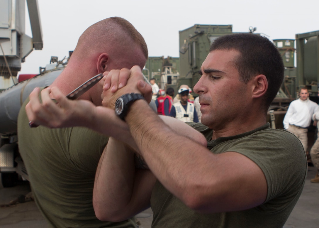 U.S. Marine Corps Lance Cpl. Jordan Leitson, right, tank driver from West Bloomfield, Mich., assigned to Battalion Landing Team 3/2, 26th Marine Expeditionary Unit (MEU), demonstrates a Marine Corps Martial Arts Program (MCMAP) technique on Lance Cpl. William Phillips, bulk fuel specialist from Bryson City, N.C., assigned to Combat Logistics  Battalion 26, 26th MEU, as they test for their brown belts in MCMAP on the boat deck of the USS Carter Hall (LSD 50), at sea, July 27, 2013. The 26th MEU is a Marine Air-Ground Task Force forward-deployed to the U.S. 5th Fleet area of responsibility aboard the Kearsarge Amphibious Ready Group serving as a sea-based, expeditionary crisis response force capable of conducting amphibious operations across the full range of military operations. (U.S. Marine Corps photo by Cpl. Michael S. Lockett/Released)