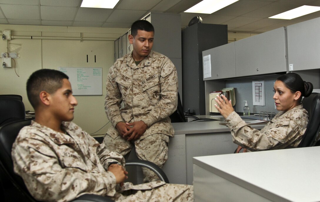MARINE CORPS BASE CAMP PENDLETON, Calif., (July 25, 2013) Sergeant Chenee Bibian (right), counsels Pfc. Diego Retamozo (left) and Lance Cpl. Albert Perez III, all administration specialists with Command Element, 15th Marine Expeditionary Unit, about the new hazing policy aboard Camp Pendleton, Calif., July 25. The Marine Corps recently made revisions to Marine Corps Order 1700.28B, which details anti-hazing regulations, to reflect the commandant’s concentration on holding commanders accountable for misconduct within their units. Bibian, 23, is from Española N.M.; Retamozo, 20, is from Perth Amboy, N.J. and Perez, 21, is a native of Los Angeles. (U.S. Marine Corps Photo by Cpl. Emmanuel Ramos/Released)