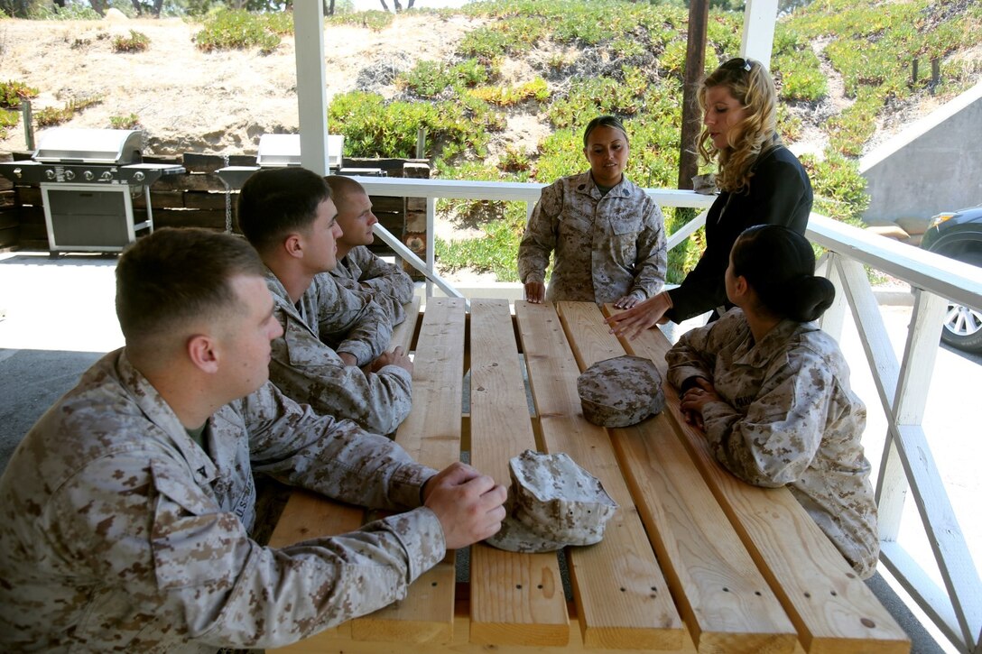 Nicole Beeson, the 1st Marine Division sexual assault response coordinator, and Gunnery Sgt. Maria Rodriguez, the lead uniformed victim advocate for 1st Marine Division, speak to Marines about sexual assault prevention at the command post here July 23, 2013. Beeson, a native of Country Club Hills, Ill., and Rodriguez, a native of Hawthorne, Calif., speak to Marines regularly to ensure they know how to prevent sexual assault and who they can seek help from in case they become a victim.