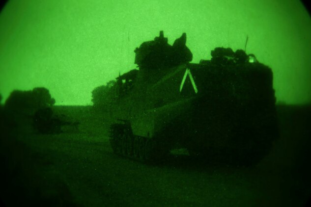 An assault amphibian vehicle of 3rd Assault Amphibian Battalion carries Marines and sailors of Echo Company, 2nd Battalion, 5th Marine Regiment, during a mechanized night raid at Combat Town 25 here, July 18, 2013. Echo Co. trained with 3rd AABn., and Special Operations and Training Group for the raid, to prepare the unit for an upcoming deployment with the 31st Marine Expeditionary Unit later this year. The raid prepared the Marines for actions against an unconventional force, which utilizes a prepared defense.